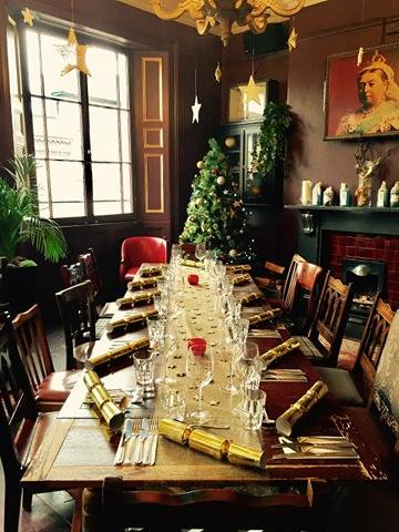 Cozy Gin Lounge with Christmas tree, ideal for holiday events and gatherings.