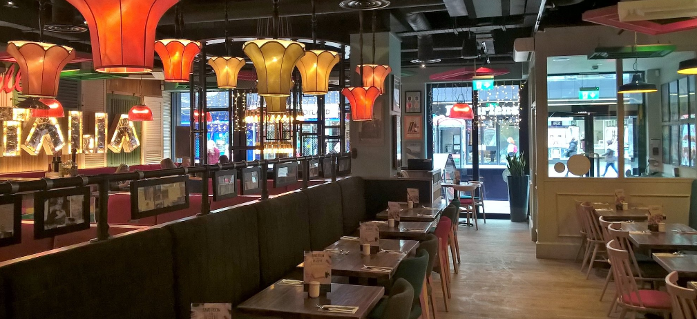 Vibrant dining space with colorful lighting for casual meetings in Bella Italia Glasgow.