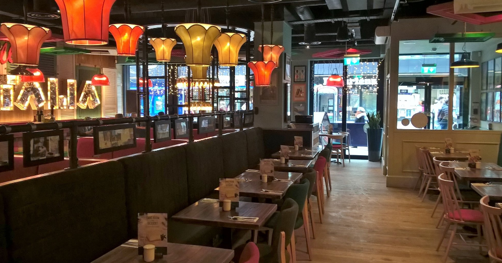 Vibrant dining space with colorful lighting at Bella Italia Glasgow for events and gatherings.