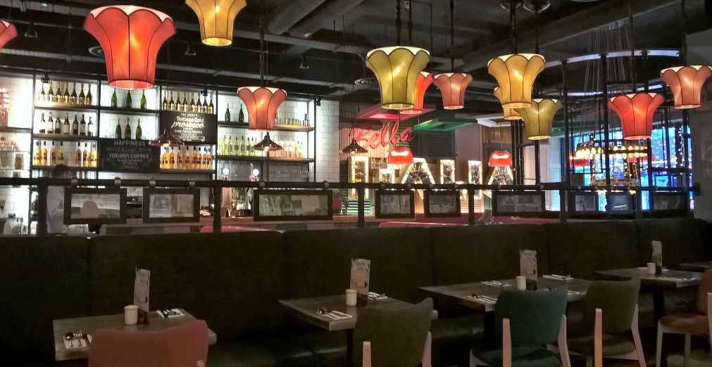 Vibrant Bella Italia Glasgow venue with colorful lights for casual meetings and events.