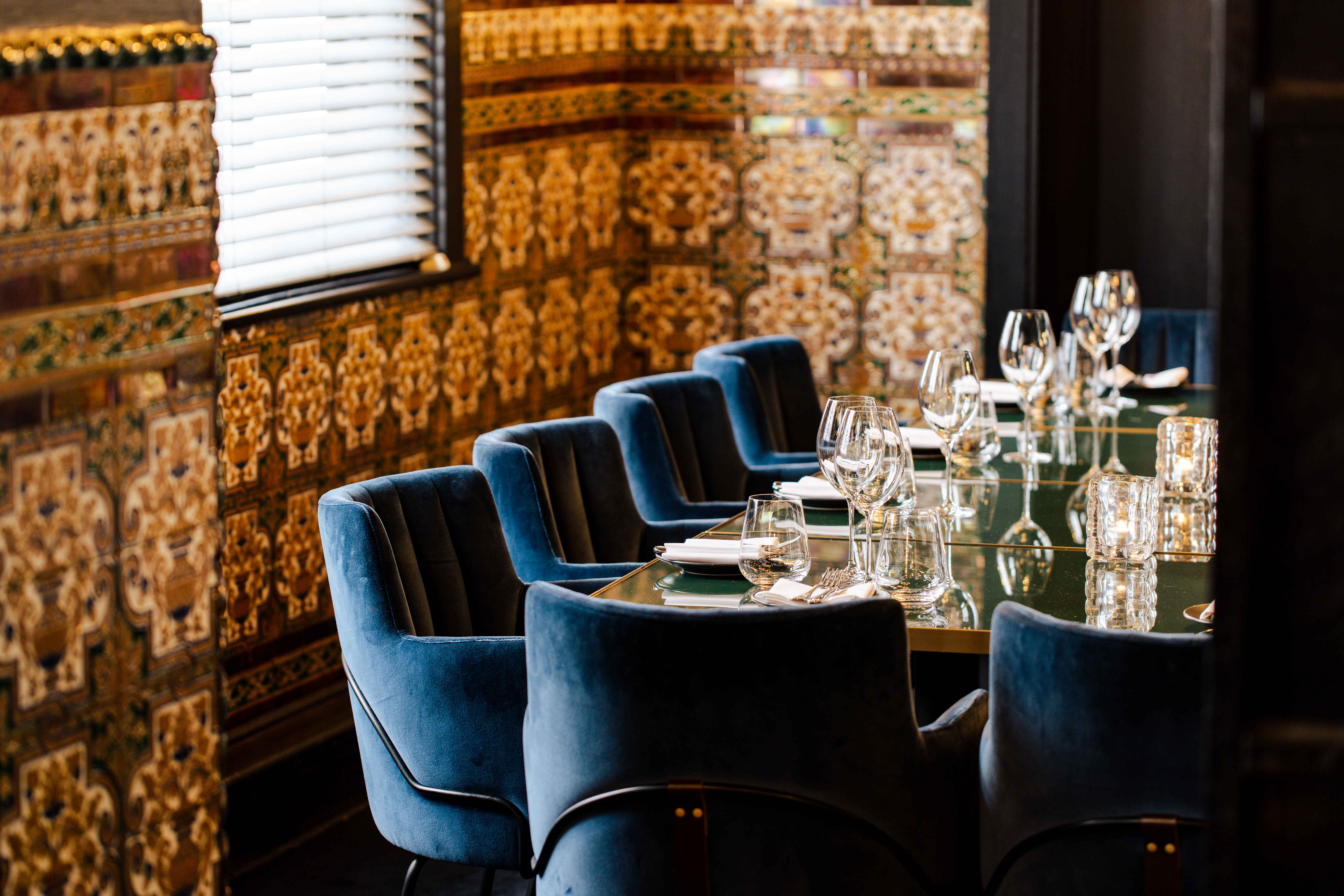 Elegant Spanish Room at Gaucho Piccadilly, featuring blue chairs for exclusive events.