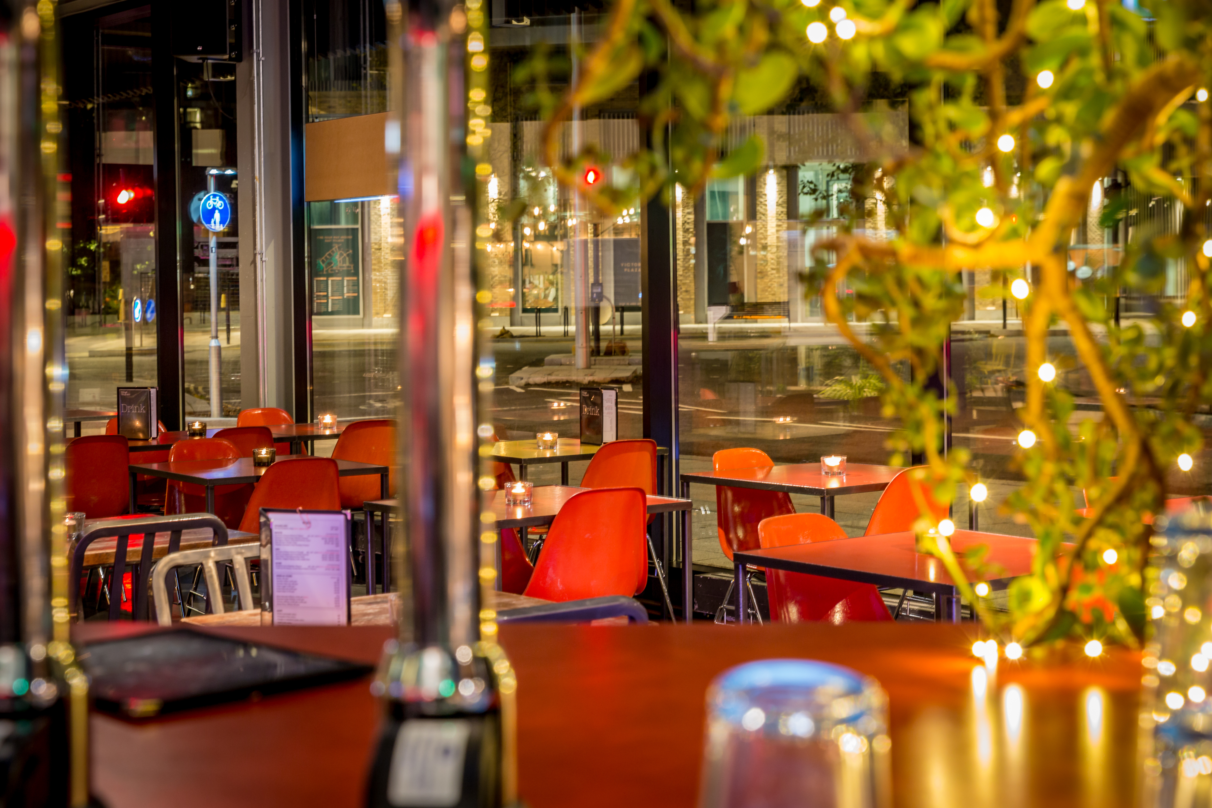 Modern dining space with red chairs, ideal for networking events and casual meetings.