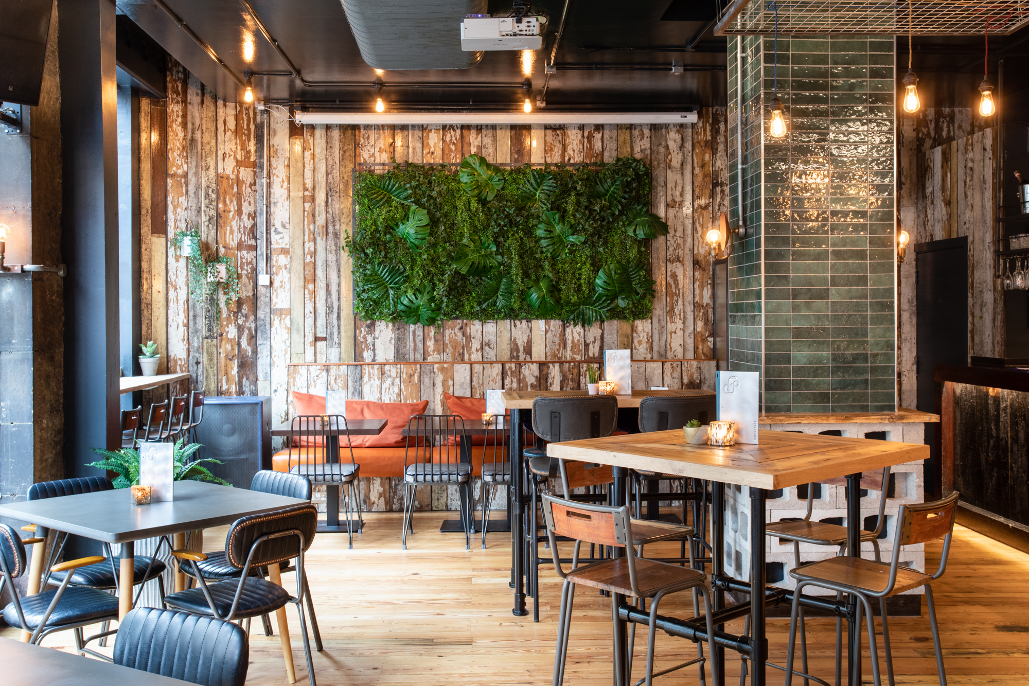 Modern restaurant event space with rustic wood accents, perfect for gatherings and dinners.