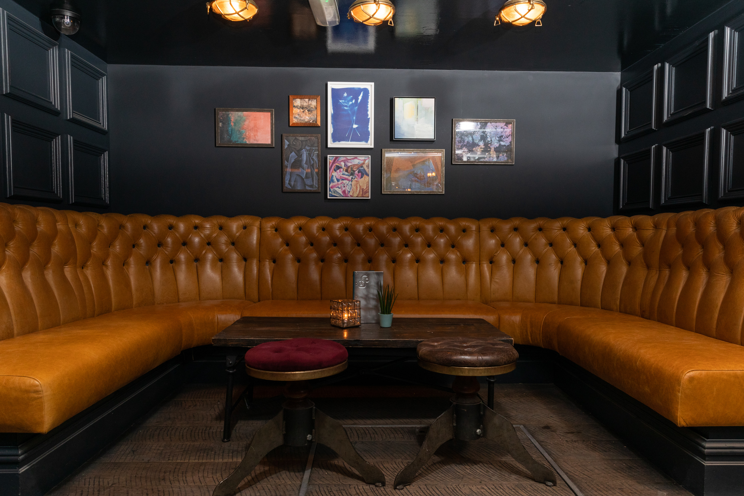 Stylish Basement Bar seating area with tufted leather for networking events.