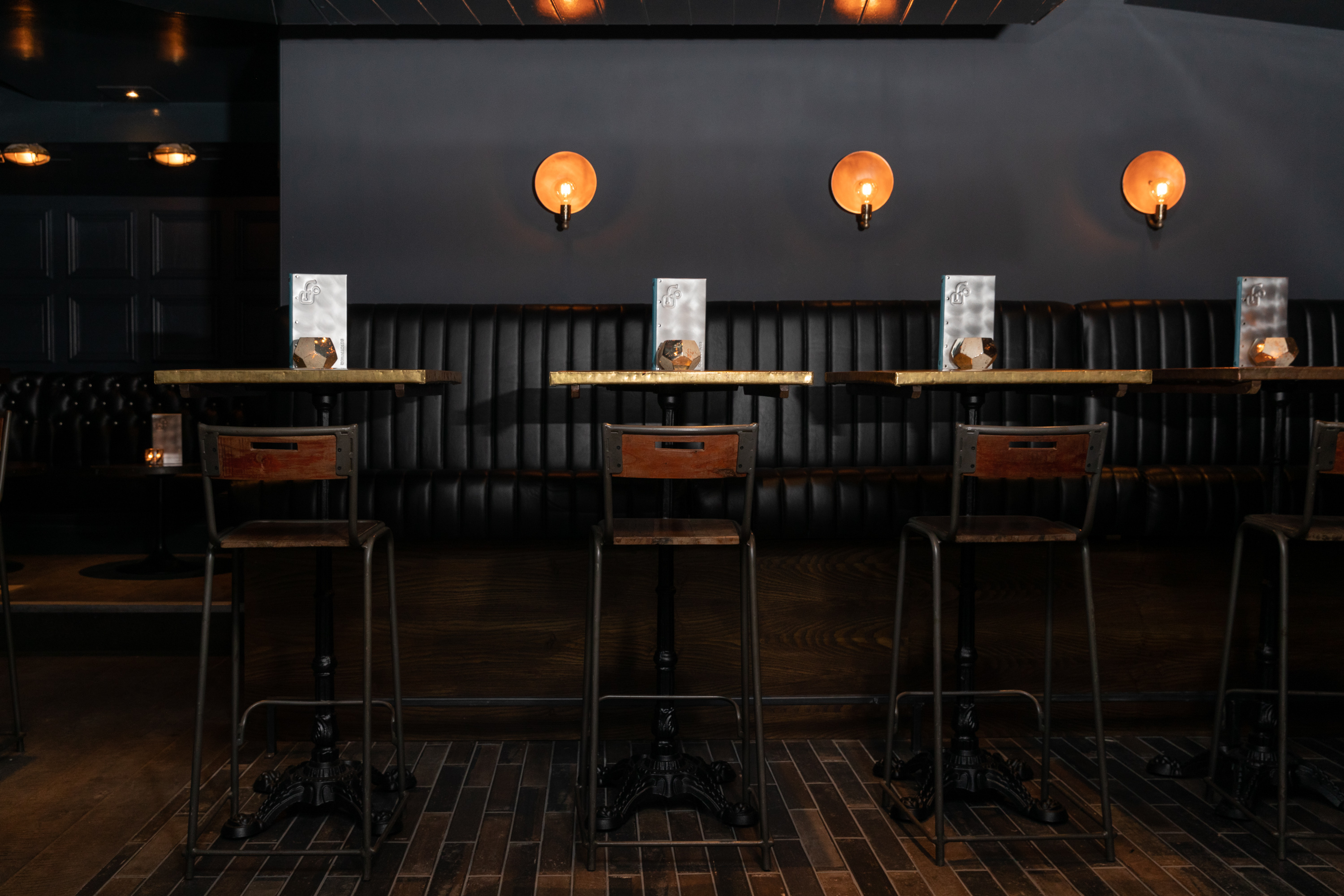 Modern Basement Bar with high-top tables, ideal for networking events and gatherings.