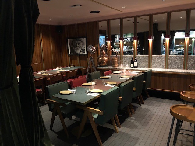 Private dining room in temper Soho with warm wood paneling, ideal for corporate events.