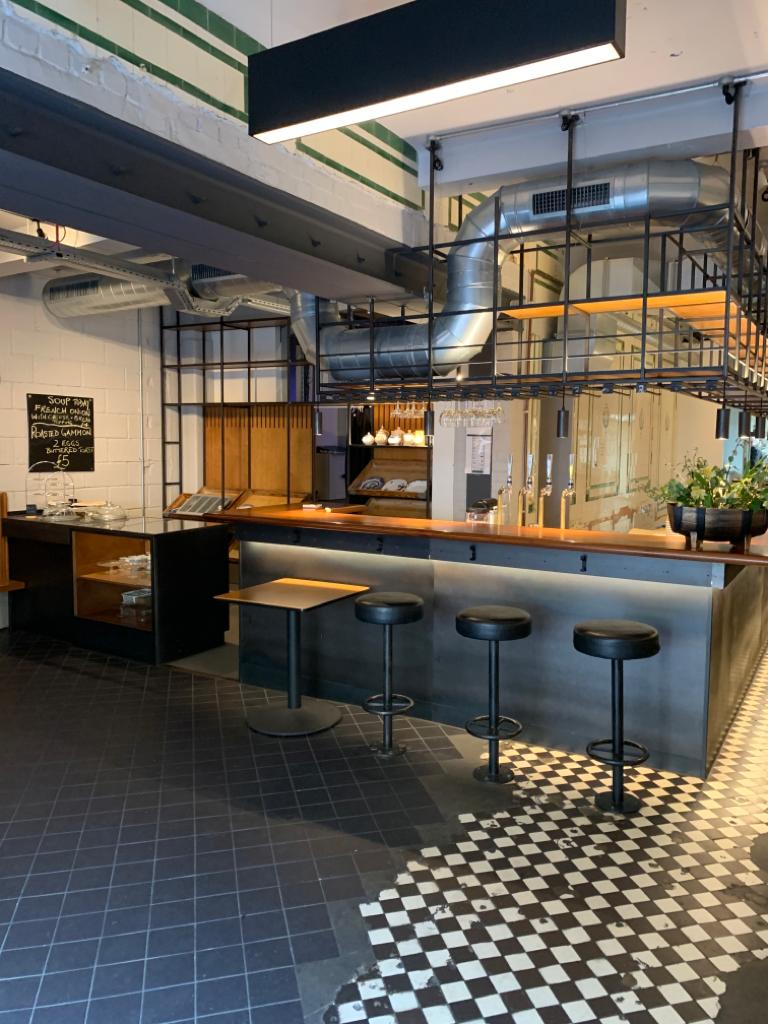 Modern bar venue in Hoxton with warm wood accents, ideal for networking events.