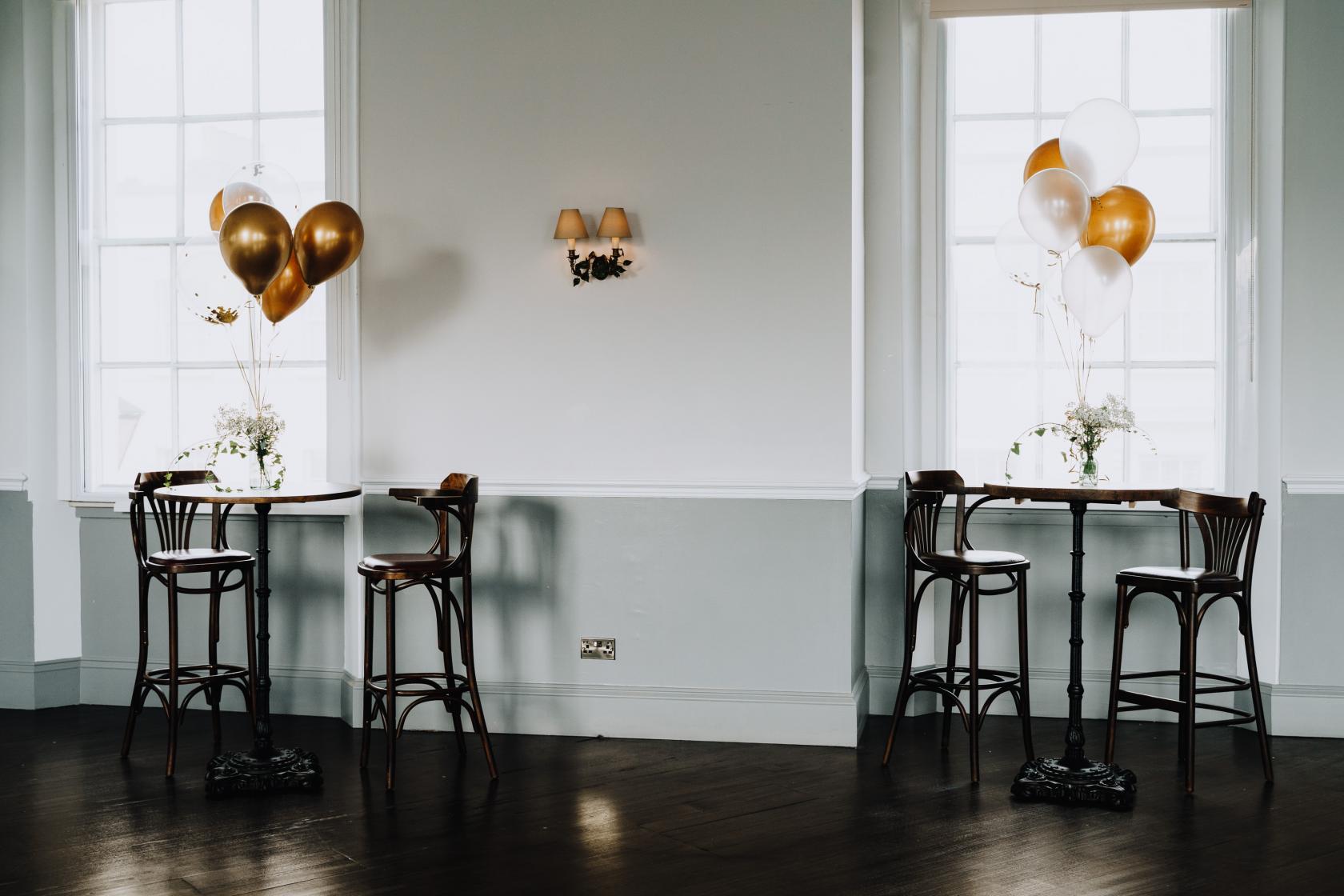 Stylish event space at The Admiral Hardy with gold and white balloons for networking.