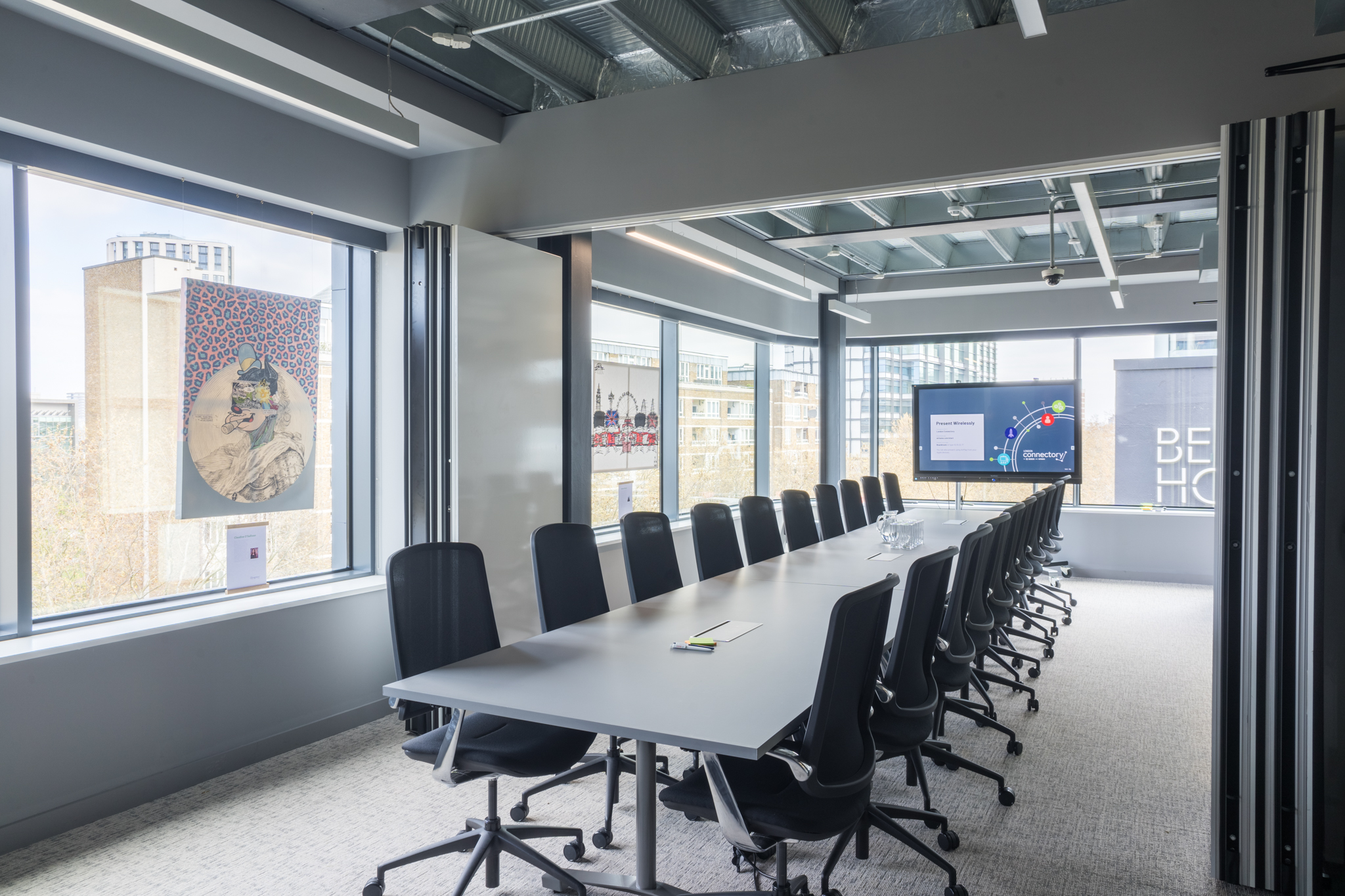 Modern London conference room with long table, ideal for meetings and events.