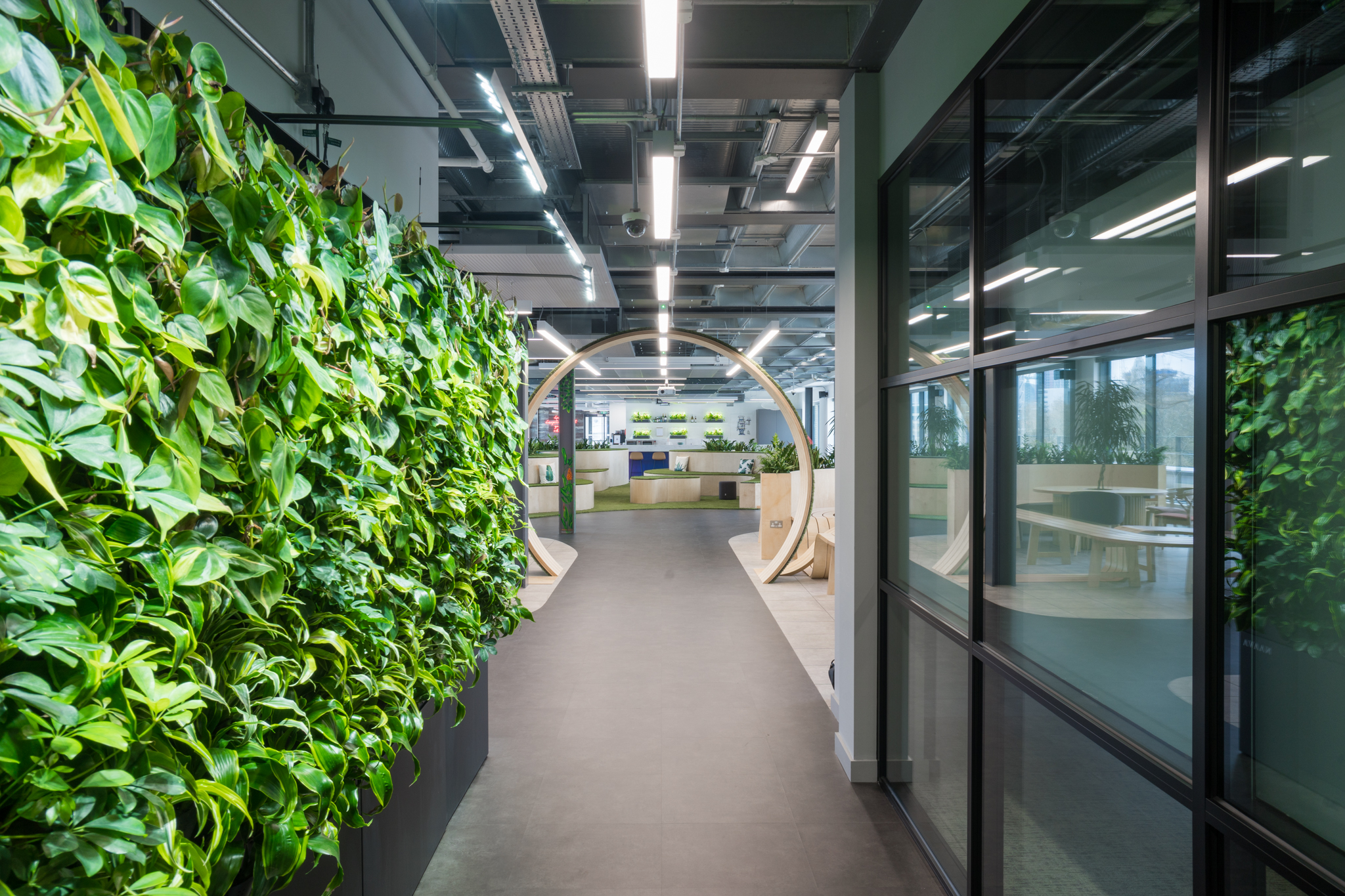Modern meeting room with greenery wall at London Connectory, ideal for workshops and events.