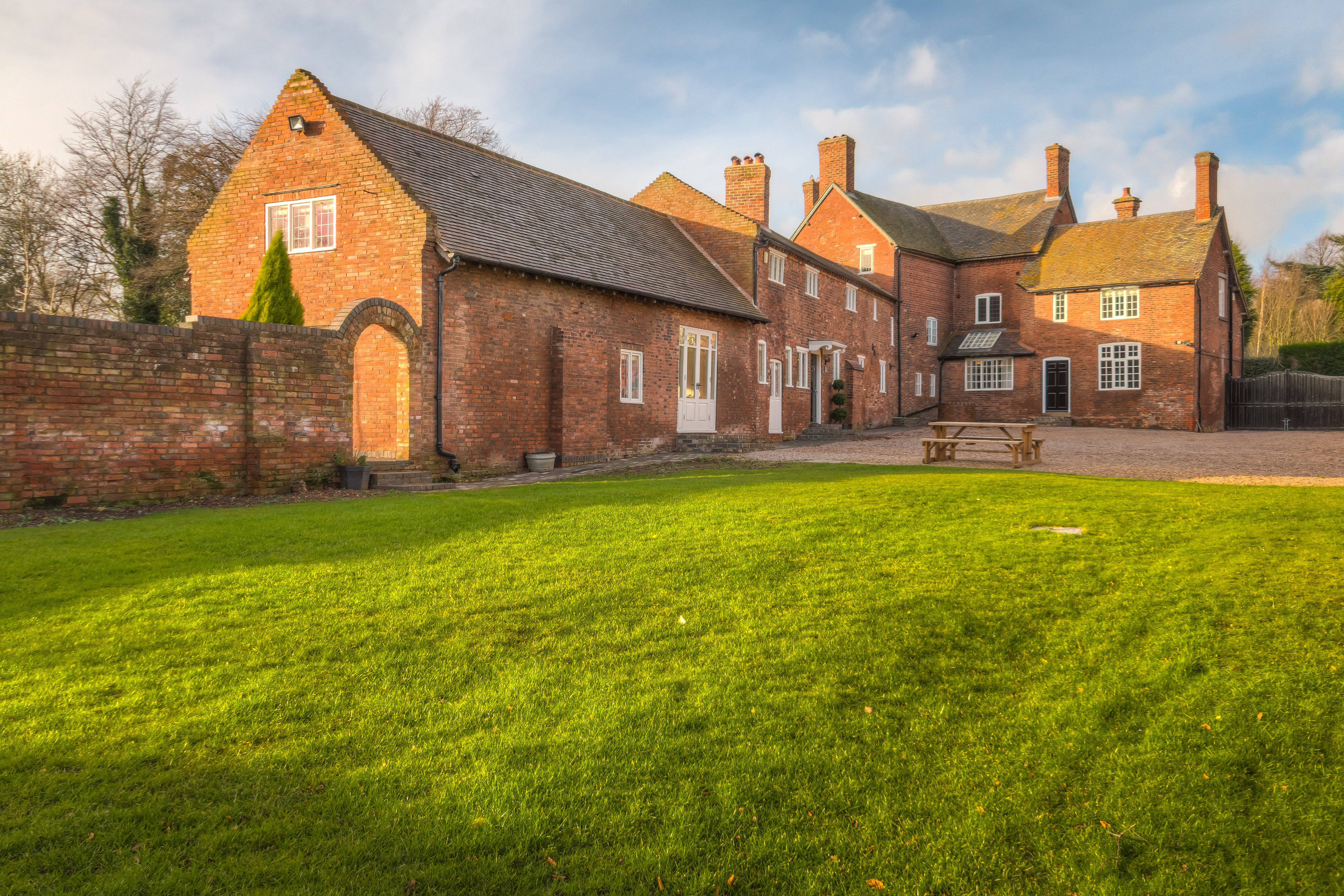 Private luxury estate venue with rustic brick architecture for intimate events.