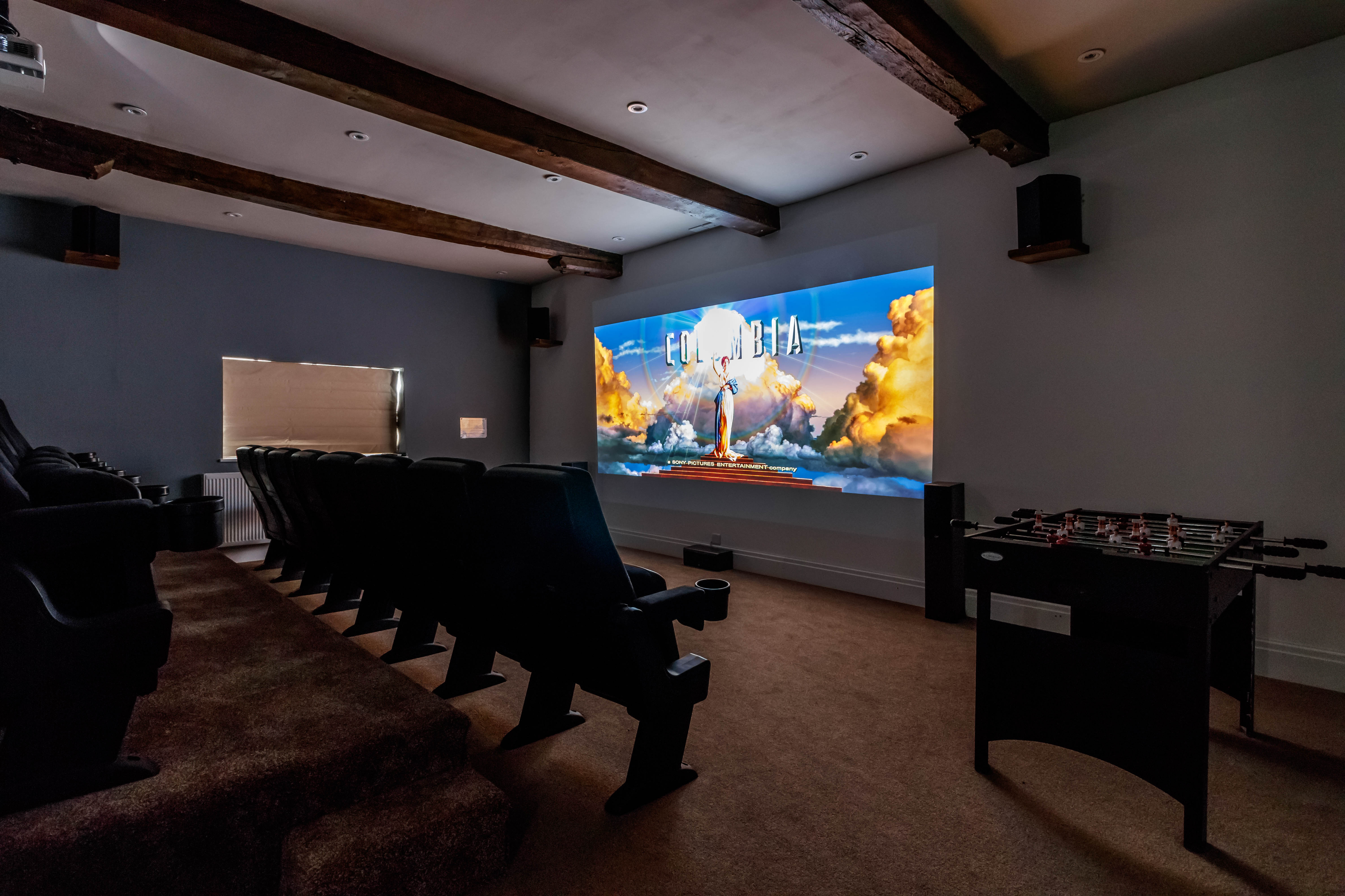 Private luxury estate screening room with plush seating for corporate events and gatherings.