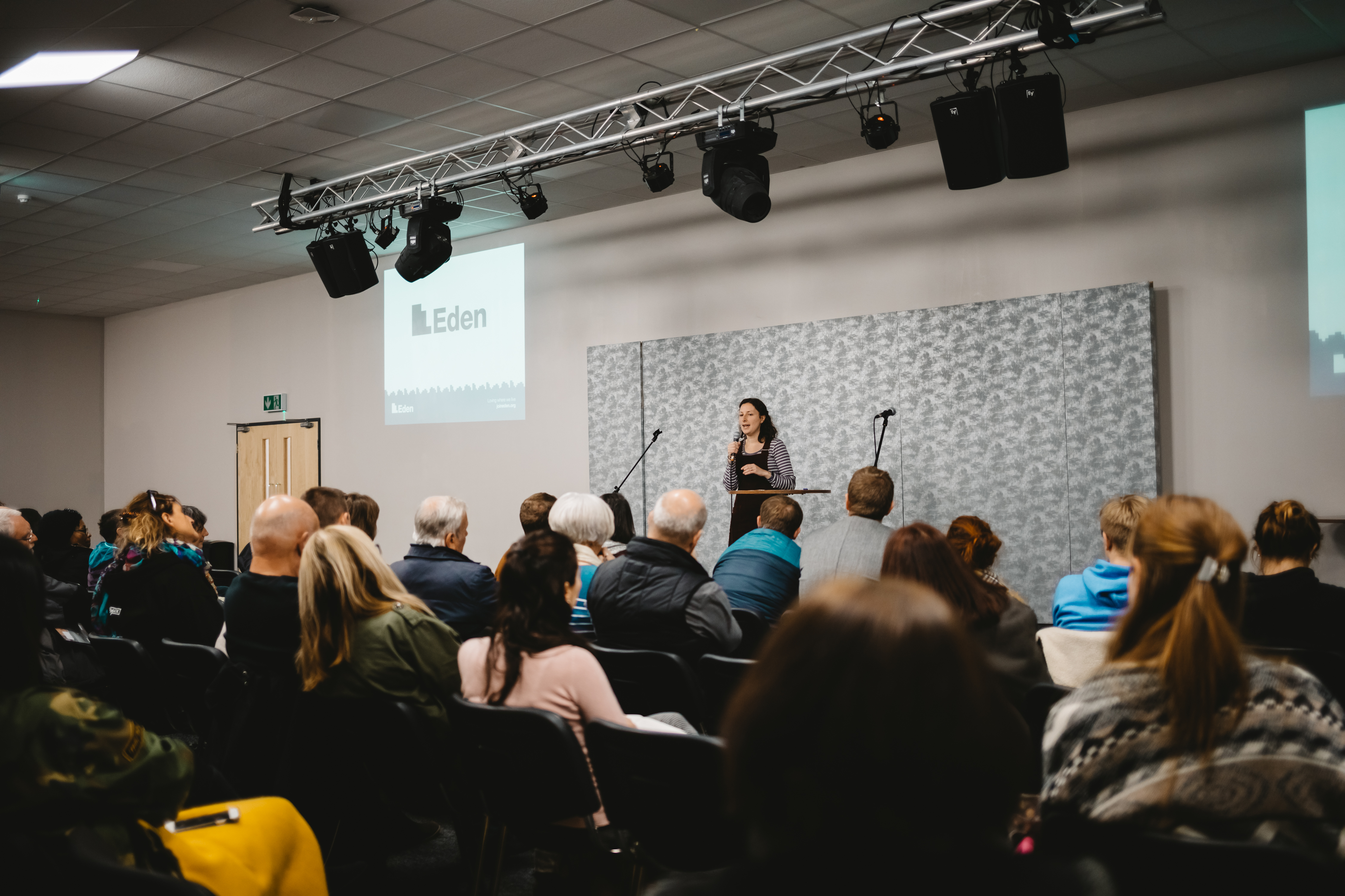Event space with speaker engaging audience, ideal for conferences and meetings.