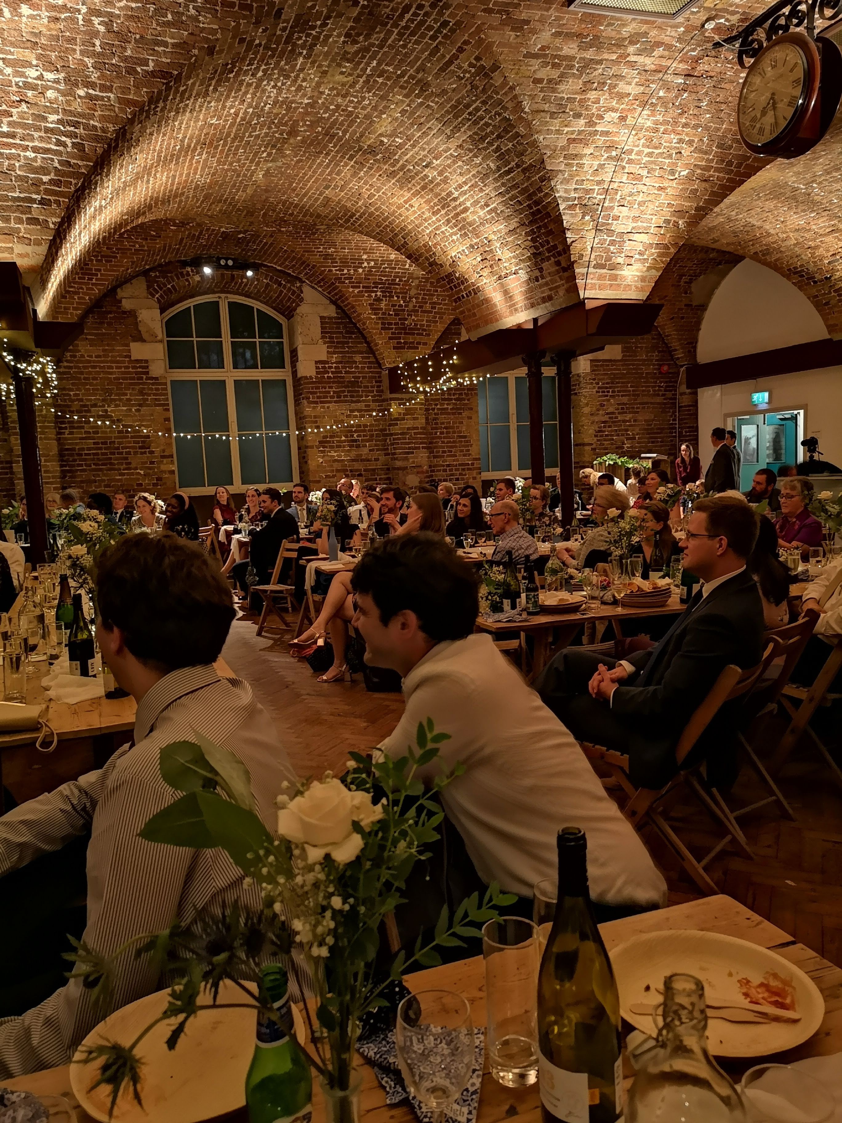 Elegant event space with long tables, ideal for weddings and corporate gatherings.