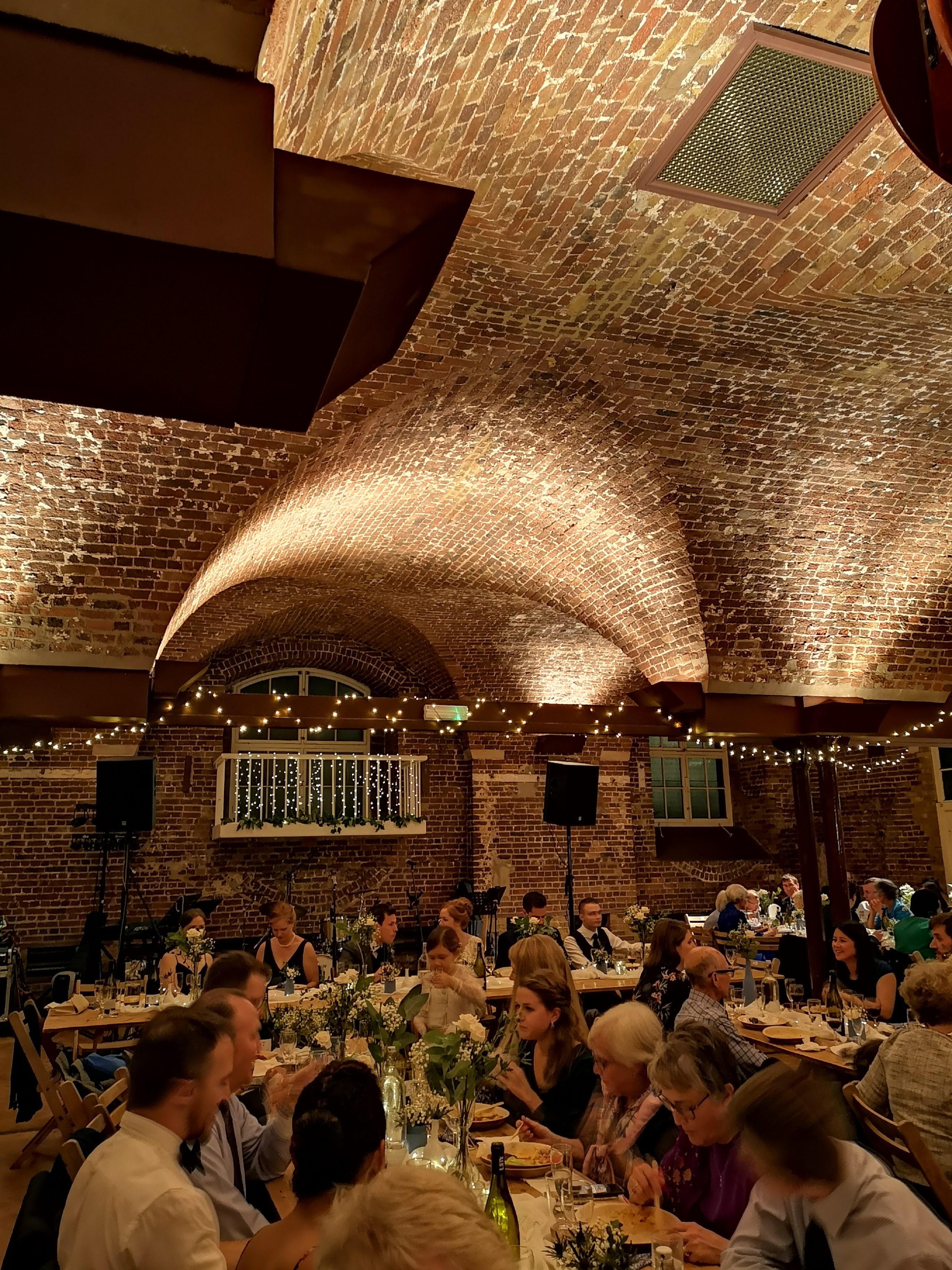 Elegant dining setup with floral centerpieces for a wedding or gala event.