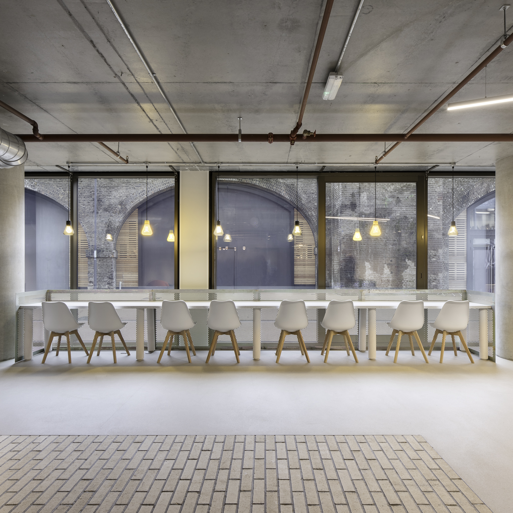 Modern meeting space with sleek table and white chairs in Boom Cycle Battersea.