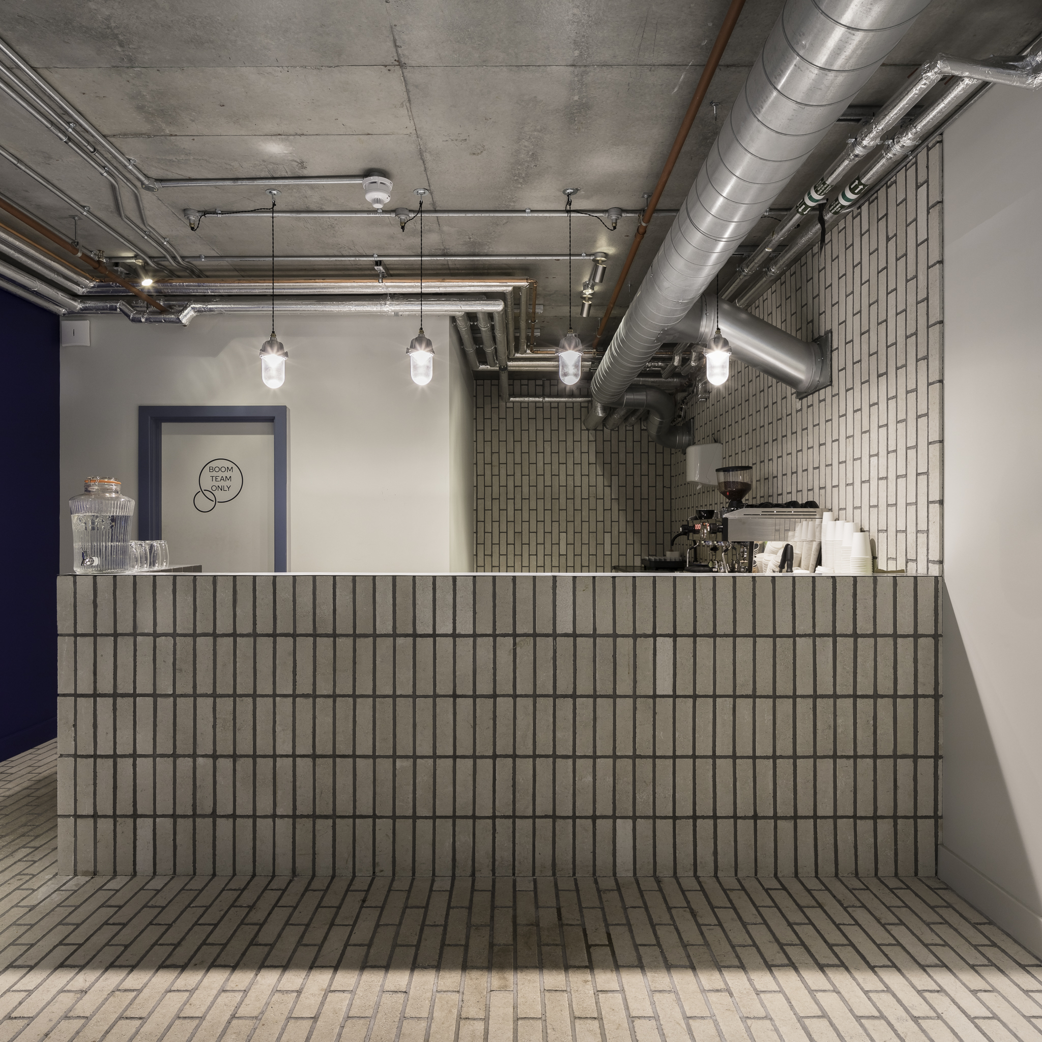 Modern reception area with coffee station for events and networking at Boom Cycle Battersea.