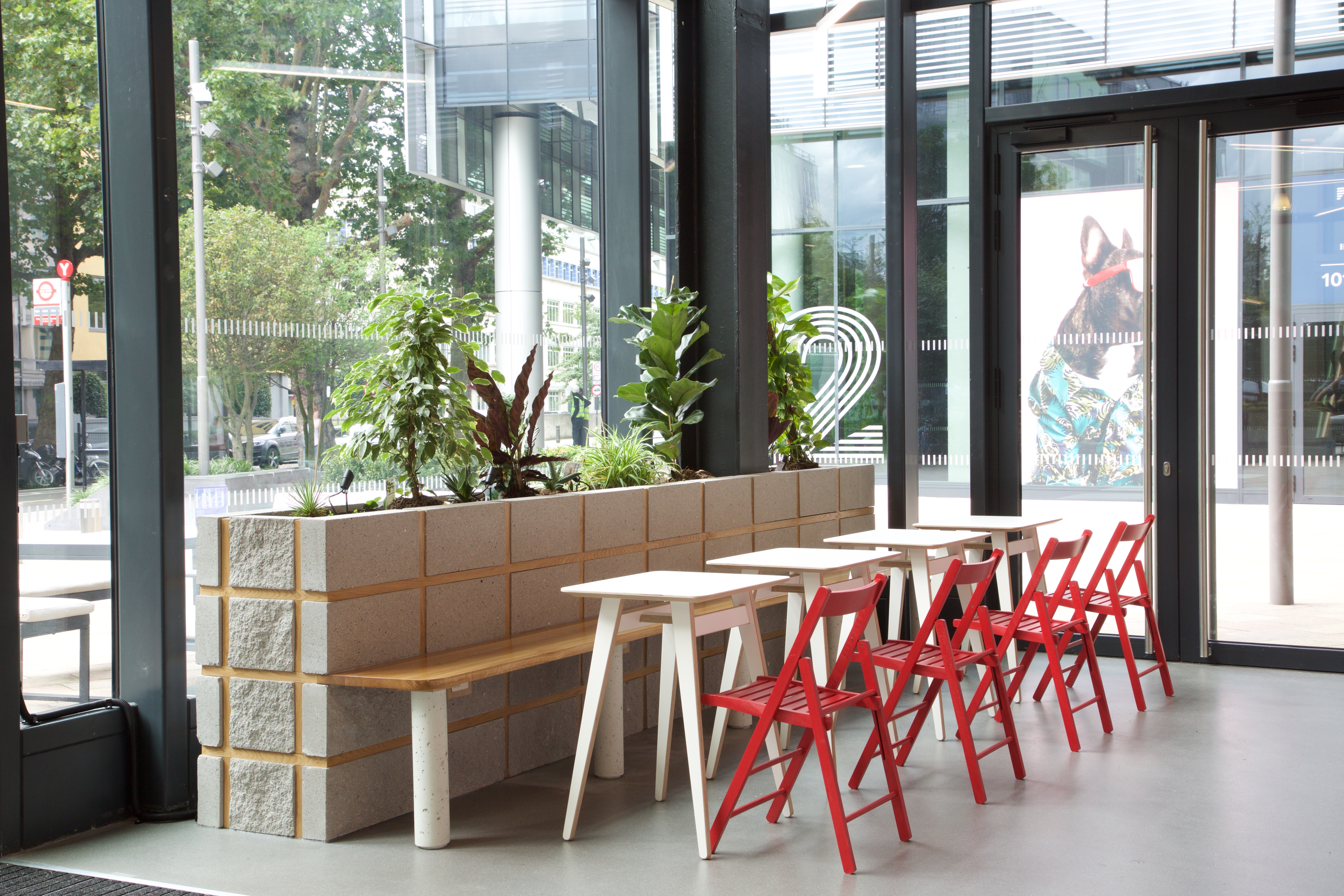 Modern reception area with greenery, ideal for networking events and casual meetings.