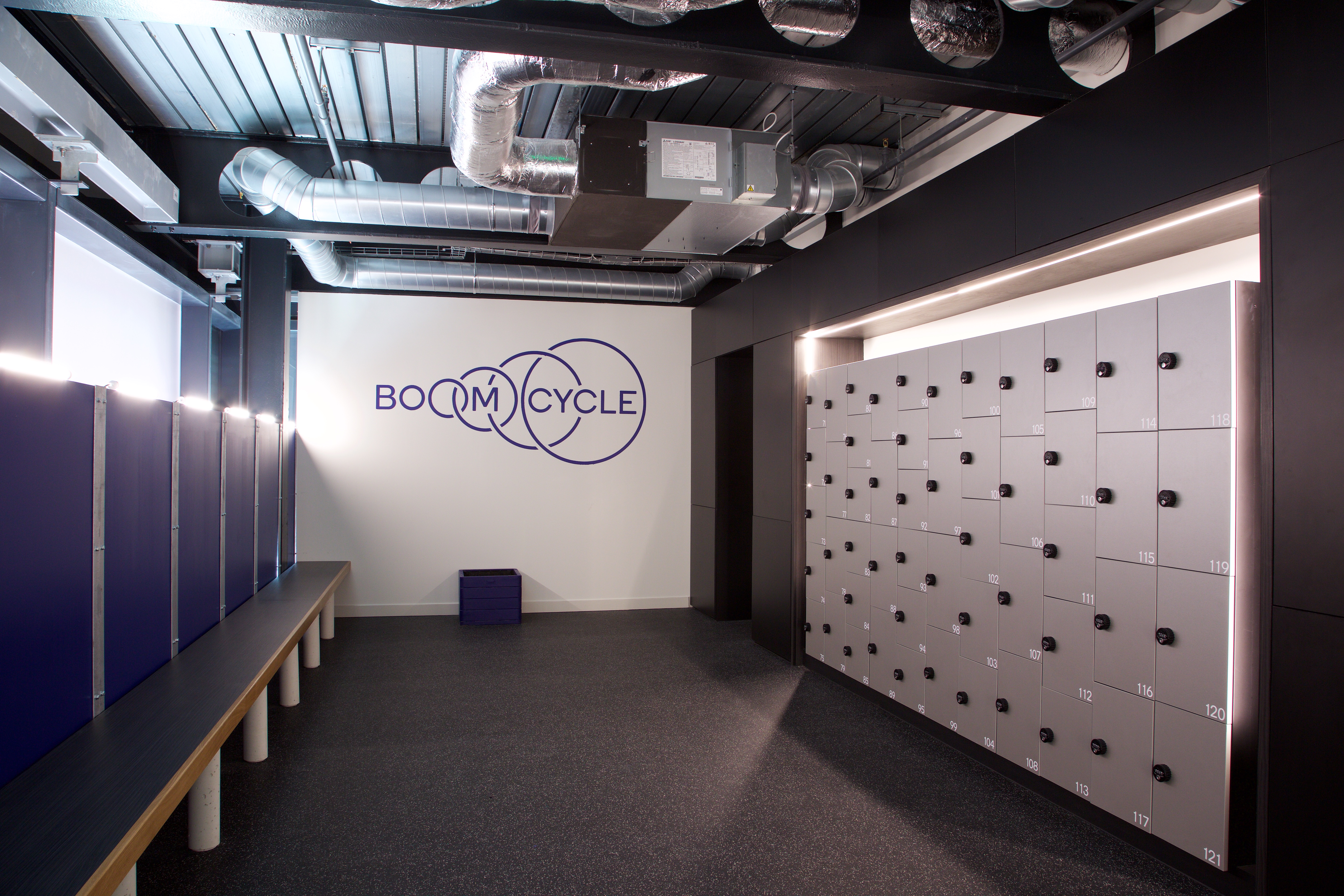 Modern fitness studio reception with sleek lockers, ideal for wellness events.