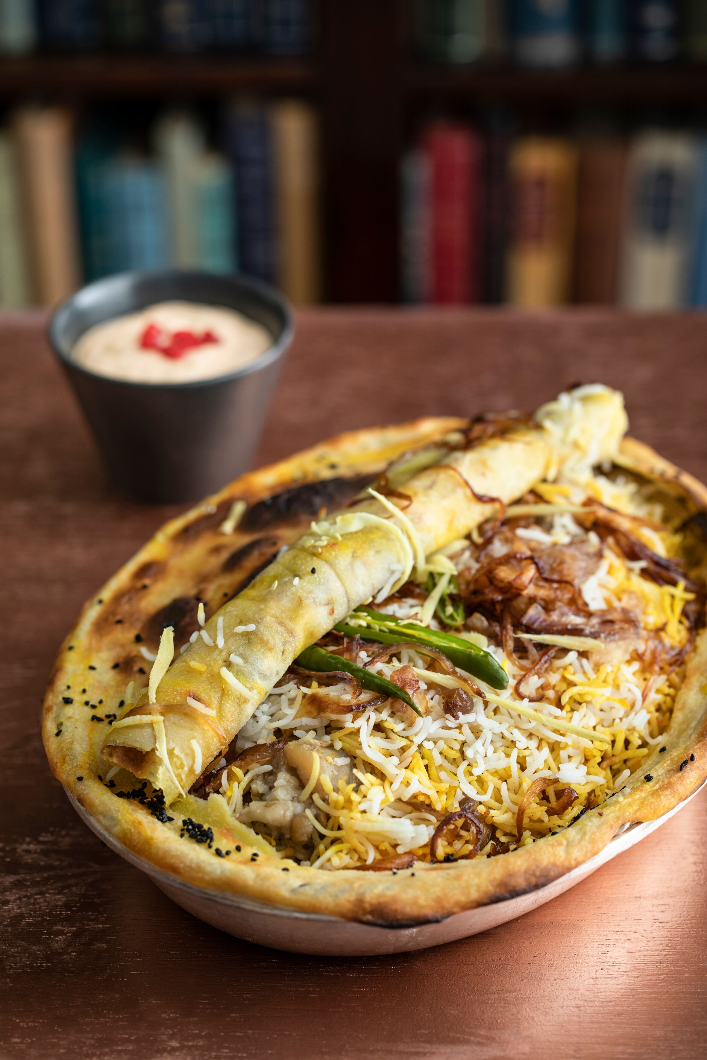 Biryani dish with crispy onions at Cinnamon Kitchen Battersea event venue.