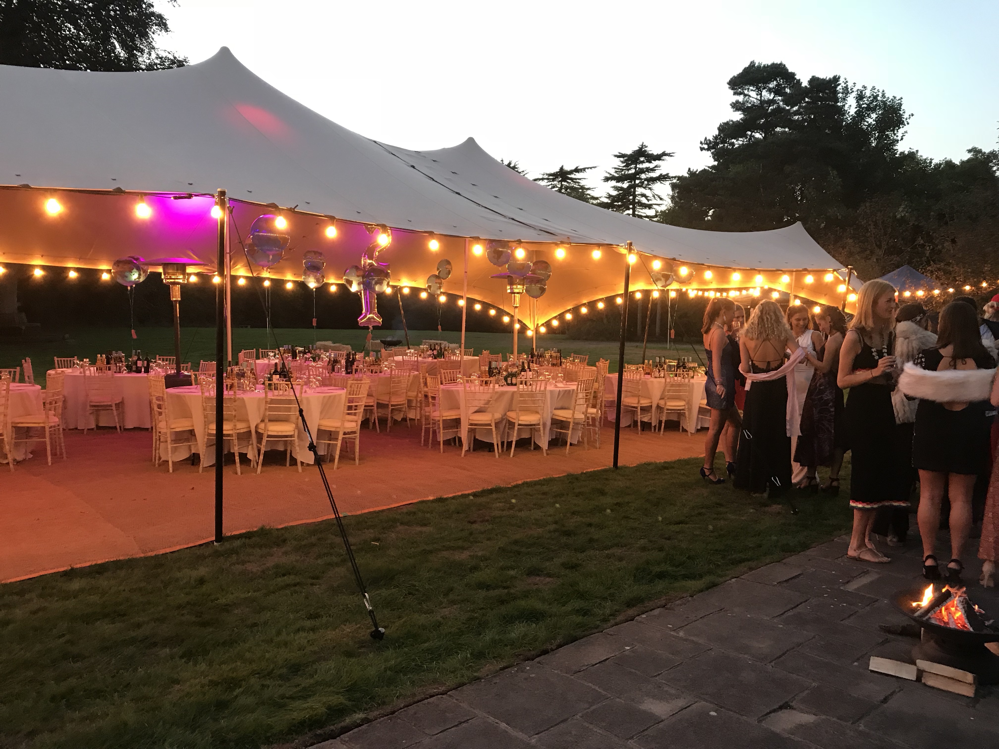 Elegant outdoor reception at Foxlea Manor with warm string lights and festive atmosphere.