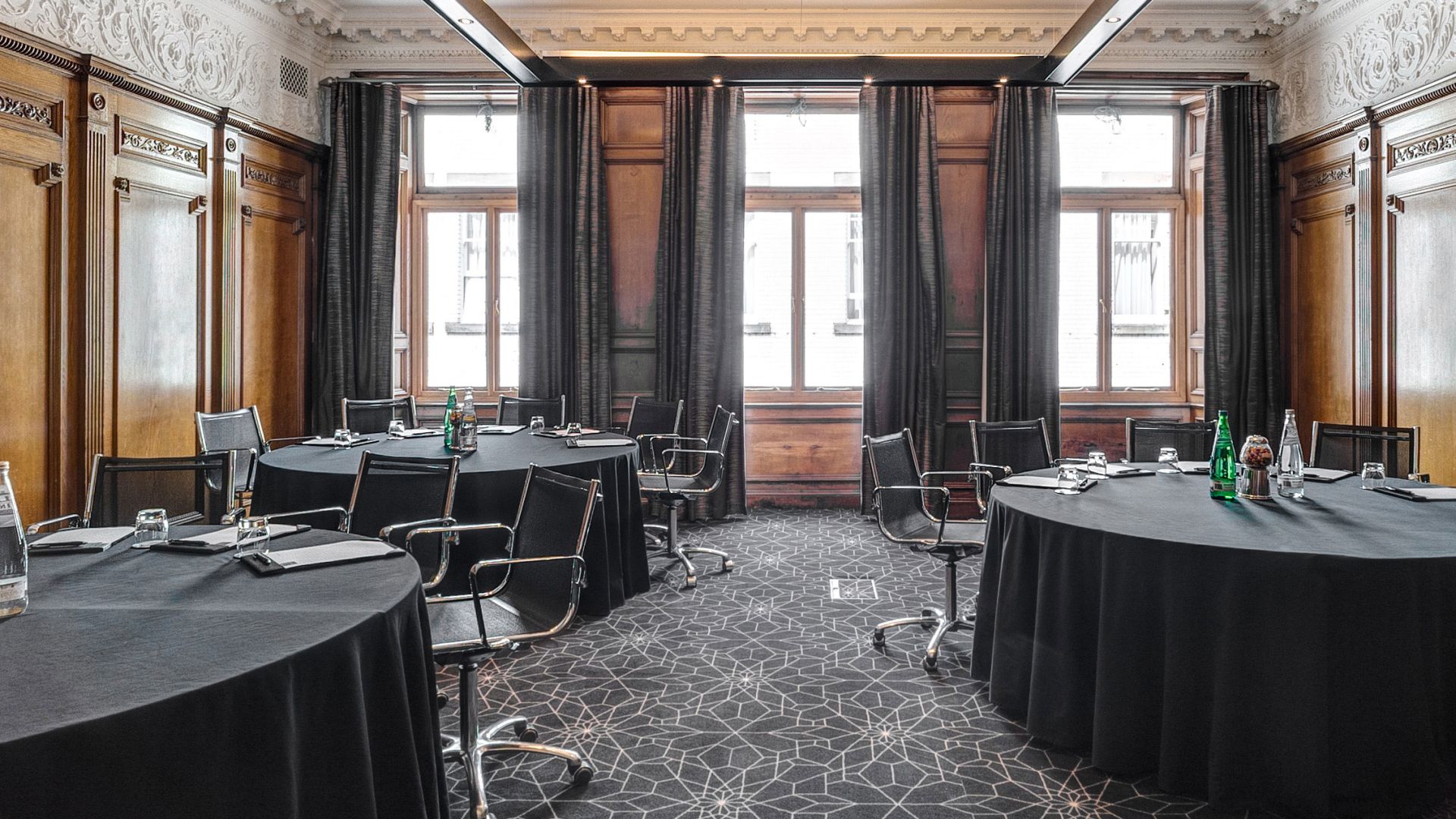 Meeting room at Apex Waterloo Place Hotel with round tables, ideal for corporate events.
