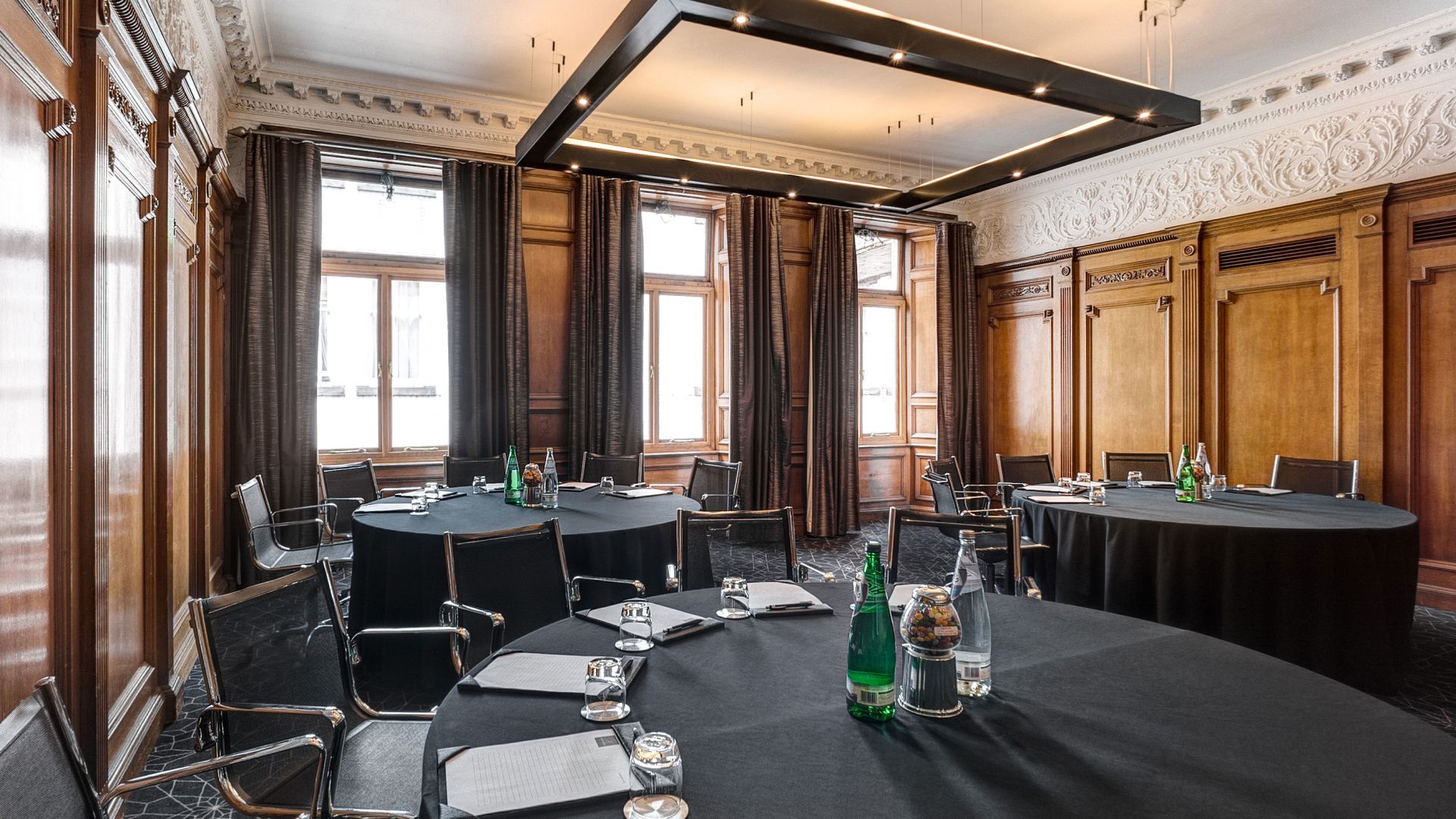 Sophisticated meeting room with wood paneling for workshops at Apex Waterloo Place Hotel.