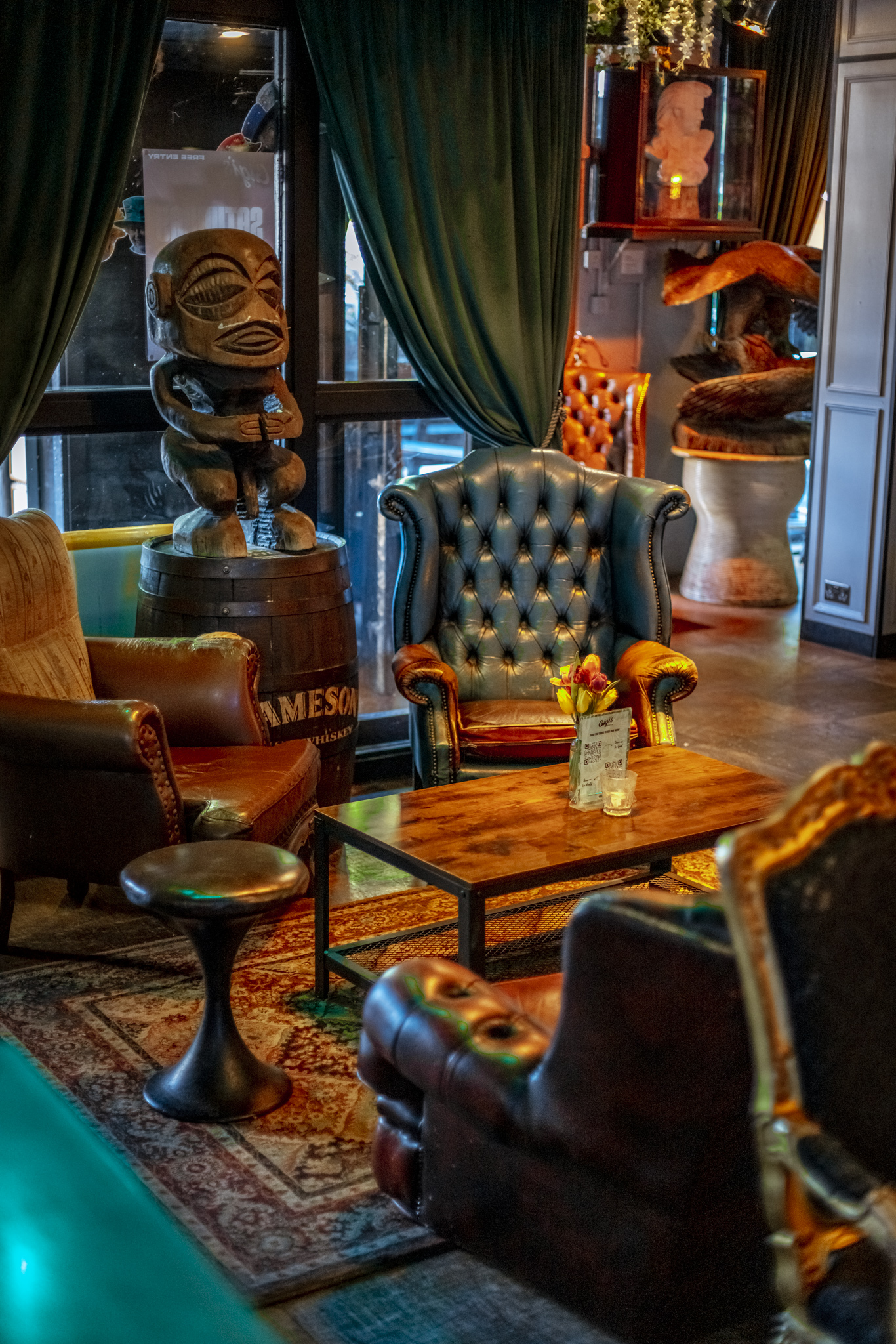 Eclectic event space at Gigi's Hoxton with wooden sculpture and plush seating.