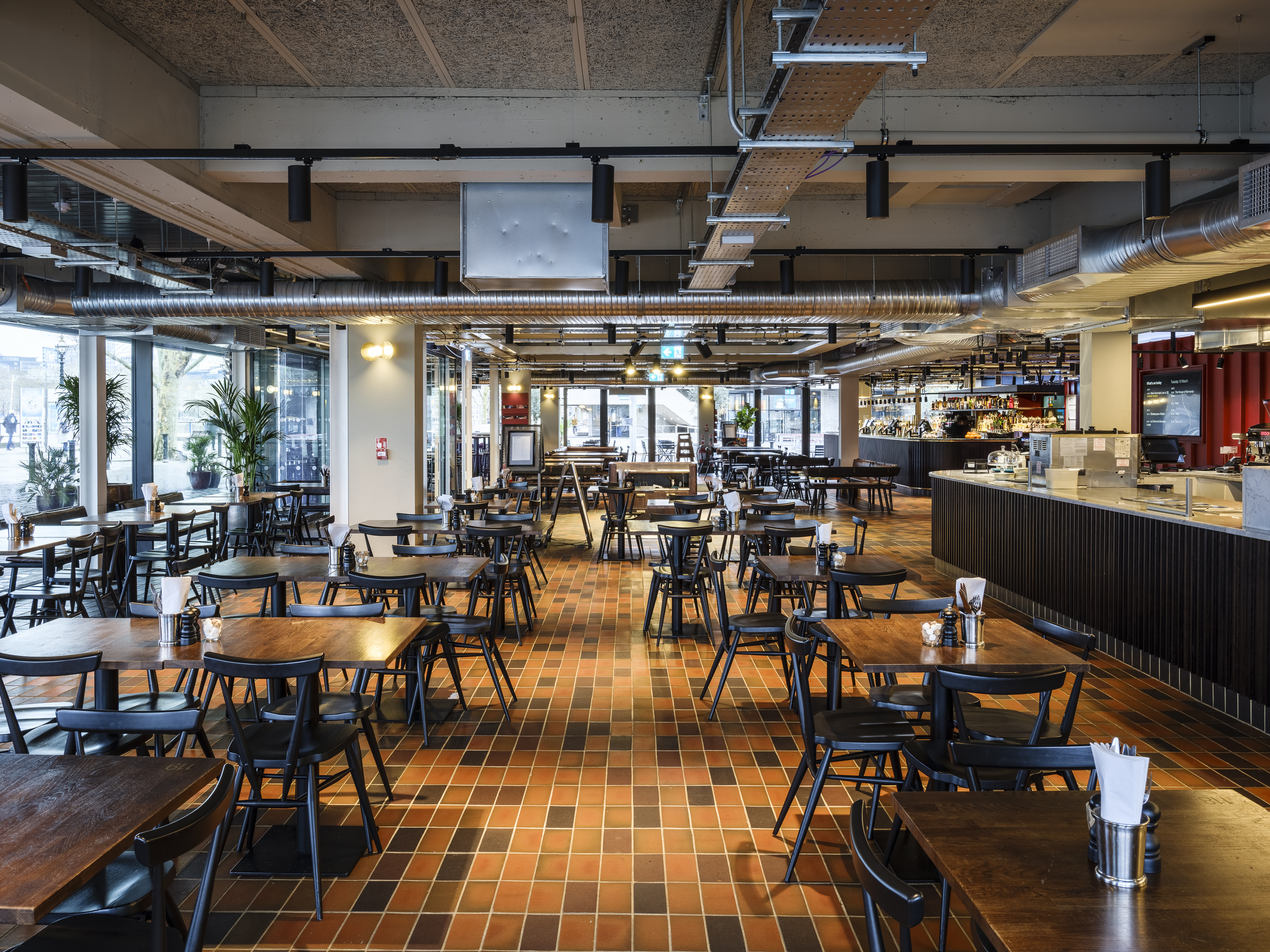 Riverfront and Balcony Bar, modern dining area with natural light for events and meetings.