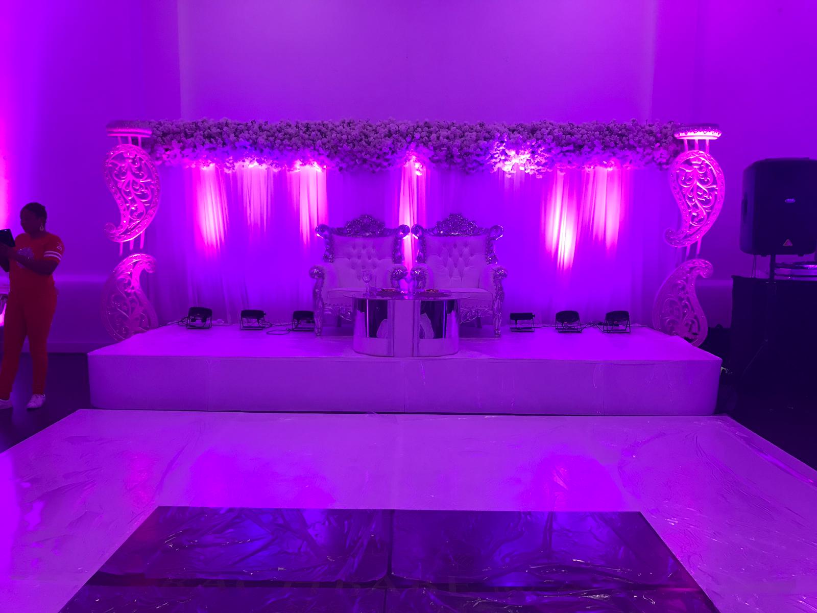 Elegant event stage with ornate thrones, ideal for weddings and celebrations.