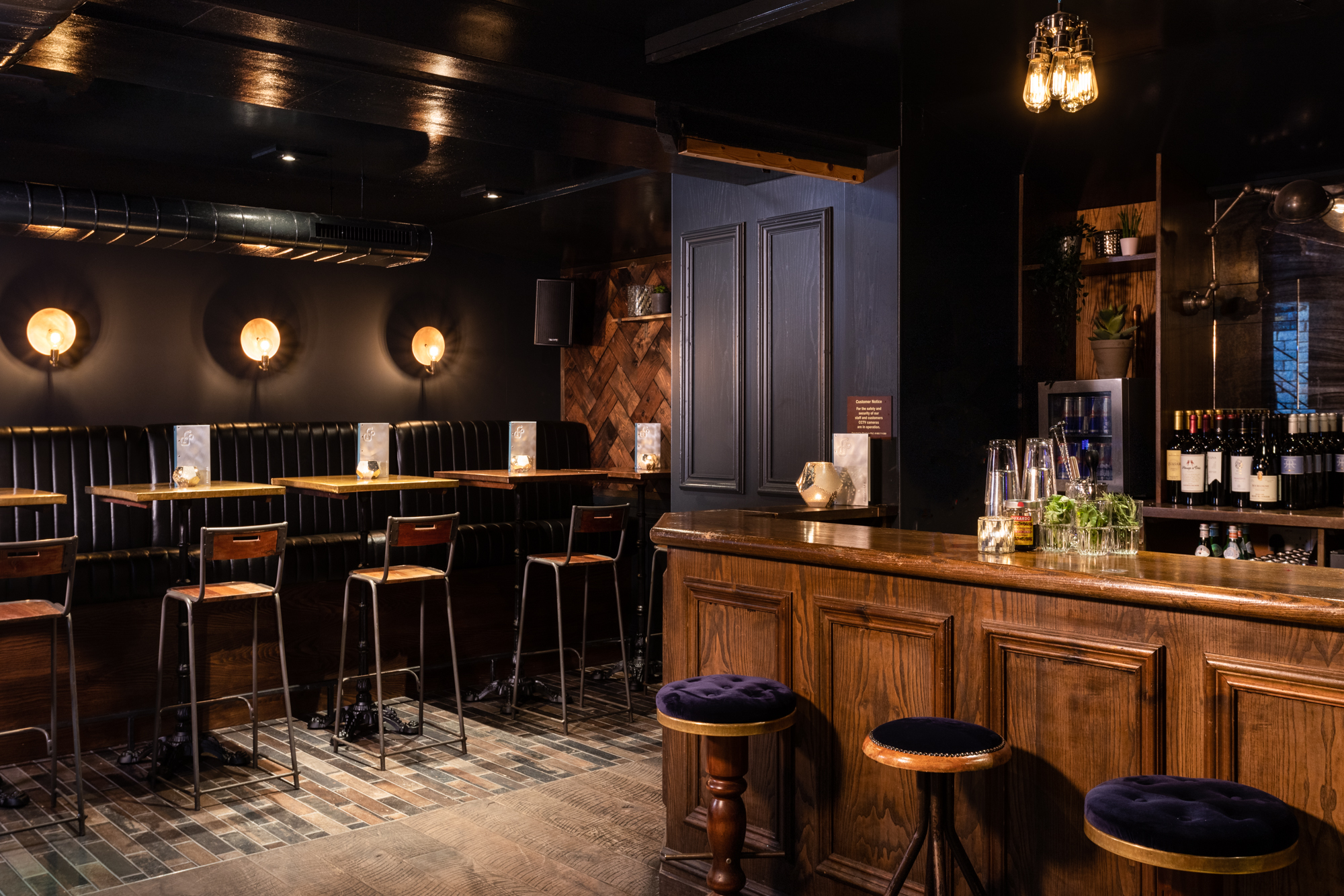 Intimate bar venue with warm lighting, perfect for networking events and gatherings.