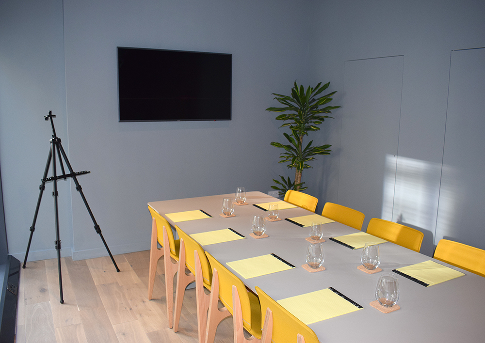 Modern meeting room at Leman Locke with yellow chairs for creative brainstorming sessions.