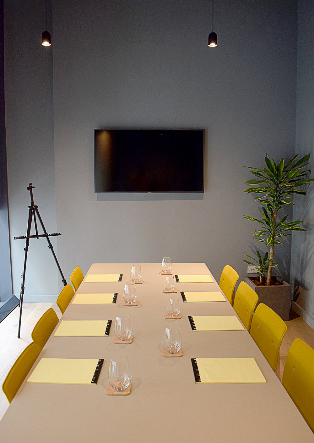 Modern meeting room at Leman Locke with yellow chairs, ideal for conferences and collaboration.