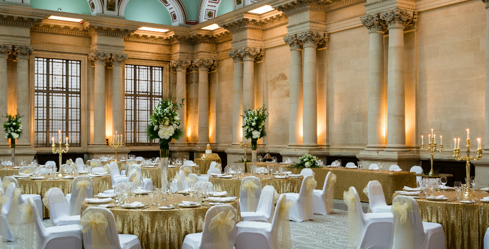 Elegant event space in Bristol Harbour Hotel with gold tablecloths for weddings and galas.