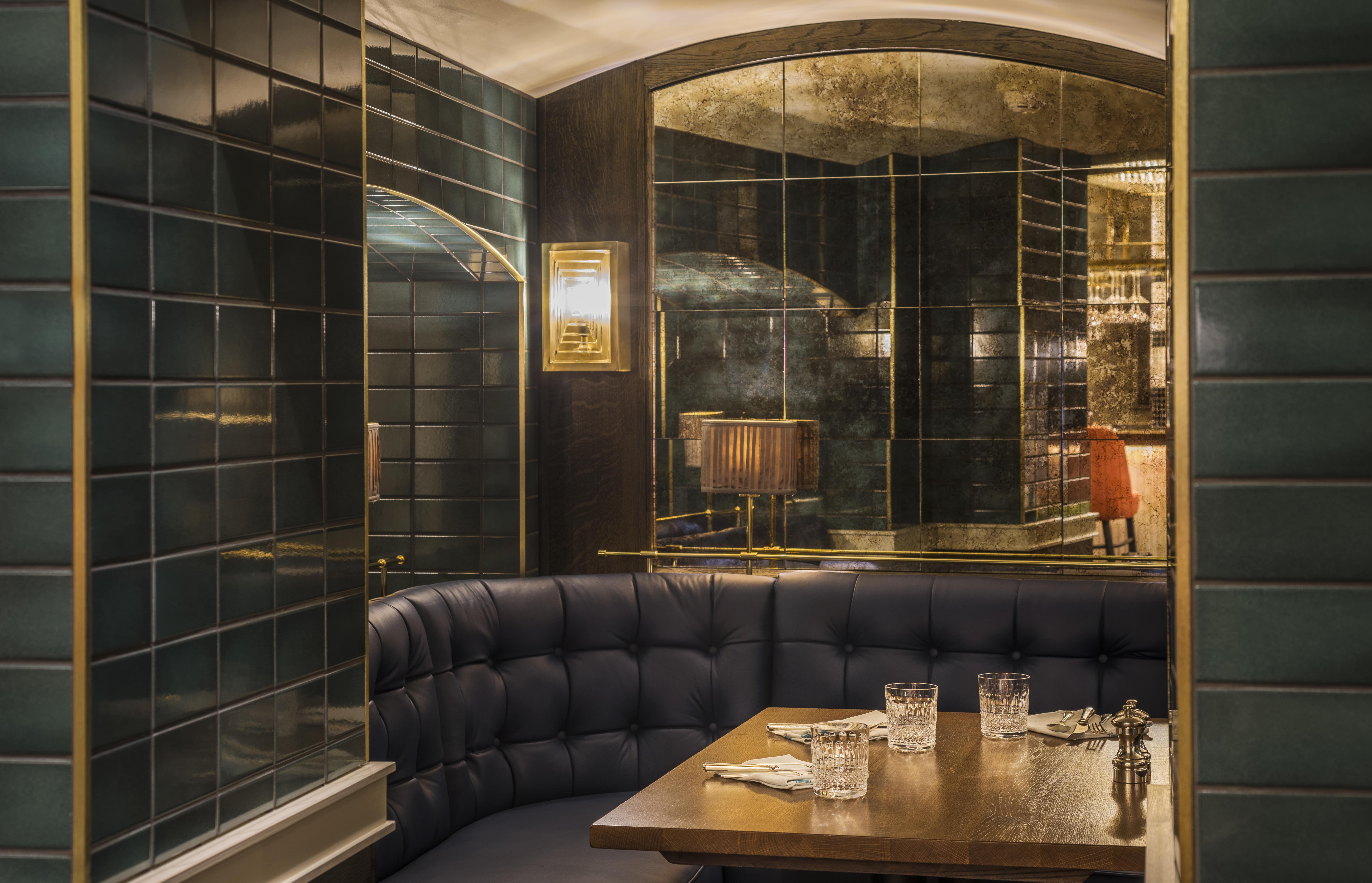 Intimate dining at Sloane Place Bar with plush banquette, ideal for networking events.