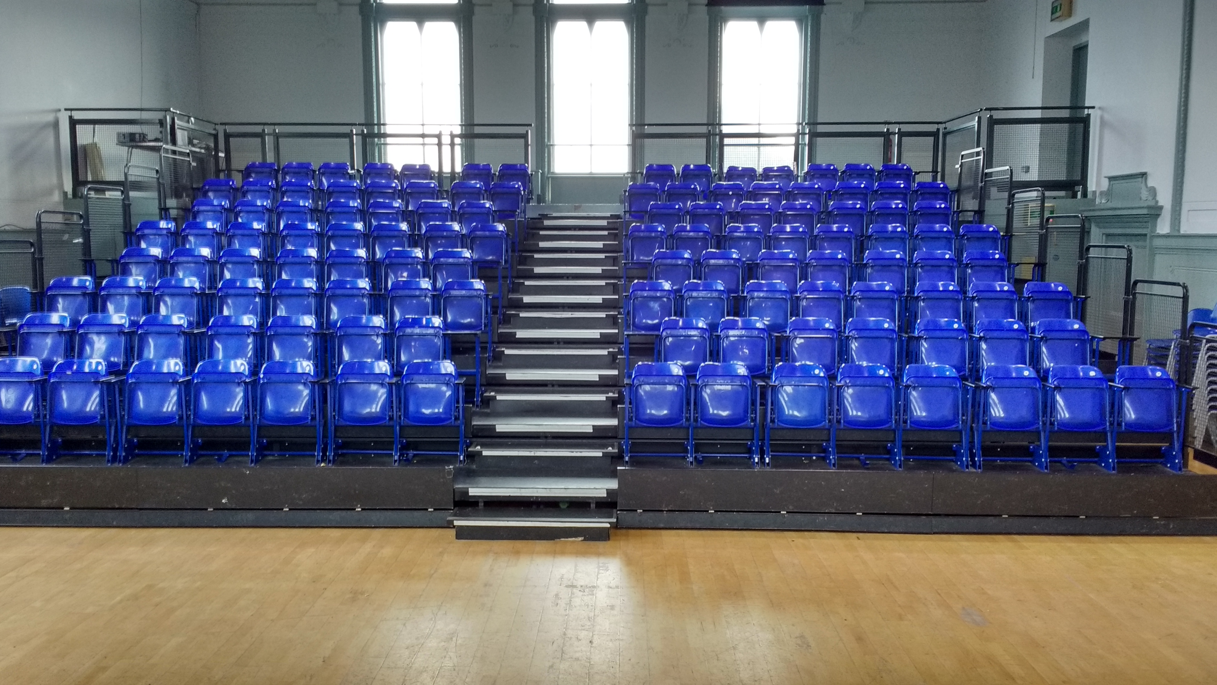 Main Hall at Wac Arts with tiered blue seating for conferences and workshops.