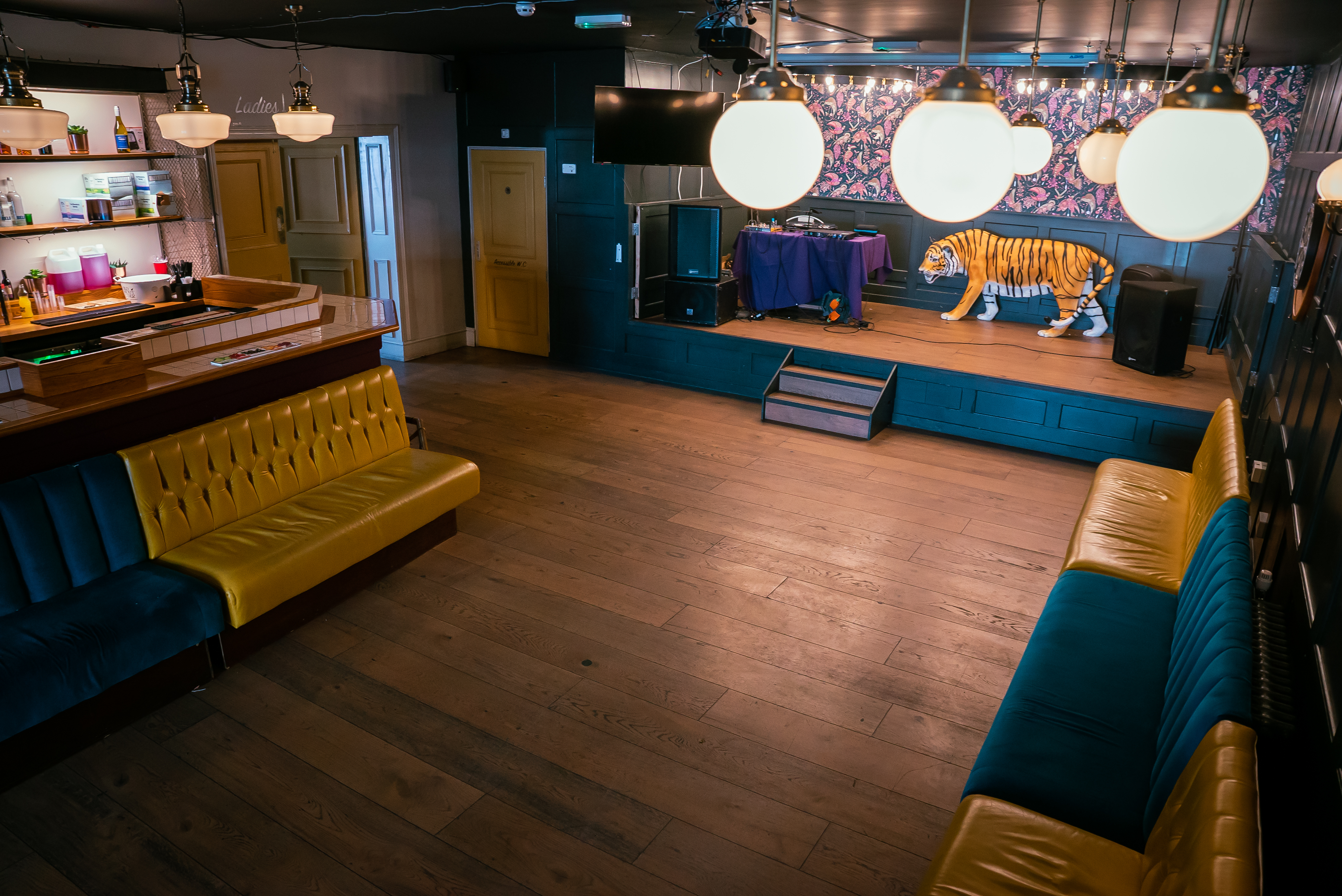 Tigers Lounge event space with stylish bar and vibrant seating for gatherings and presentations.