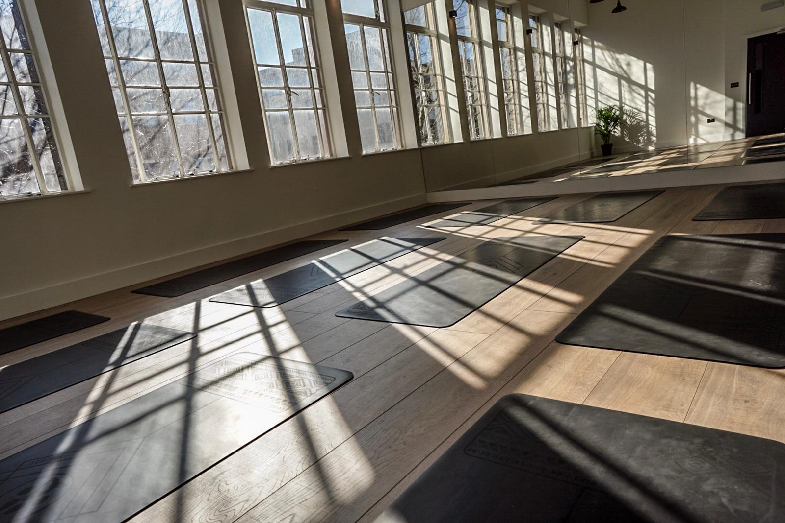 Spacious wellness studio with yoga mats, perfect for mindfulness events and retreats.