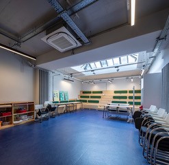 Versatile Training Room B with natural light, ideal for workshops and presentations.