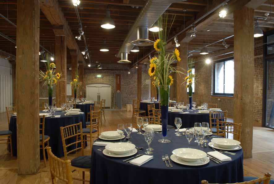 Elegant event space at London Museum Docklands with floral centerpieces for corporate gatherings.