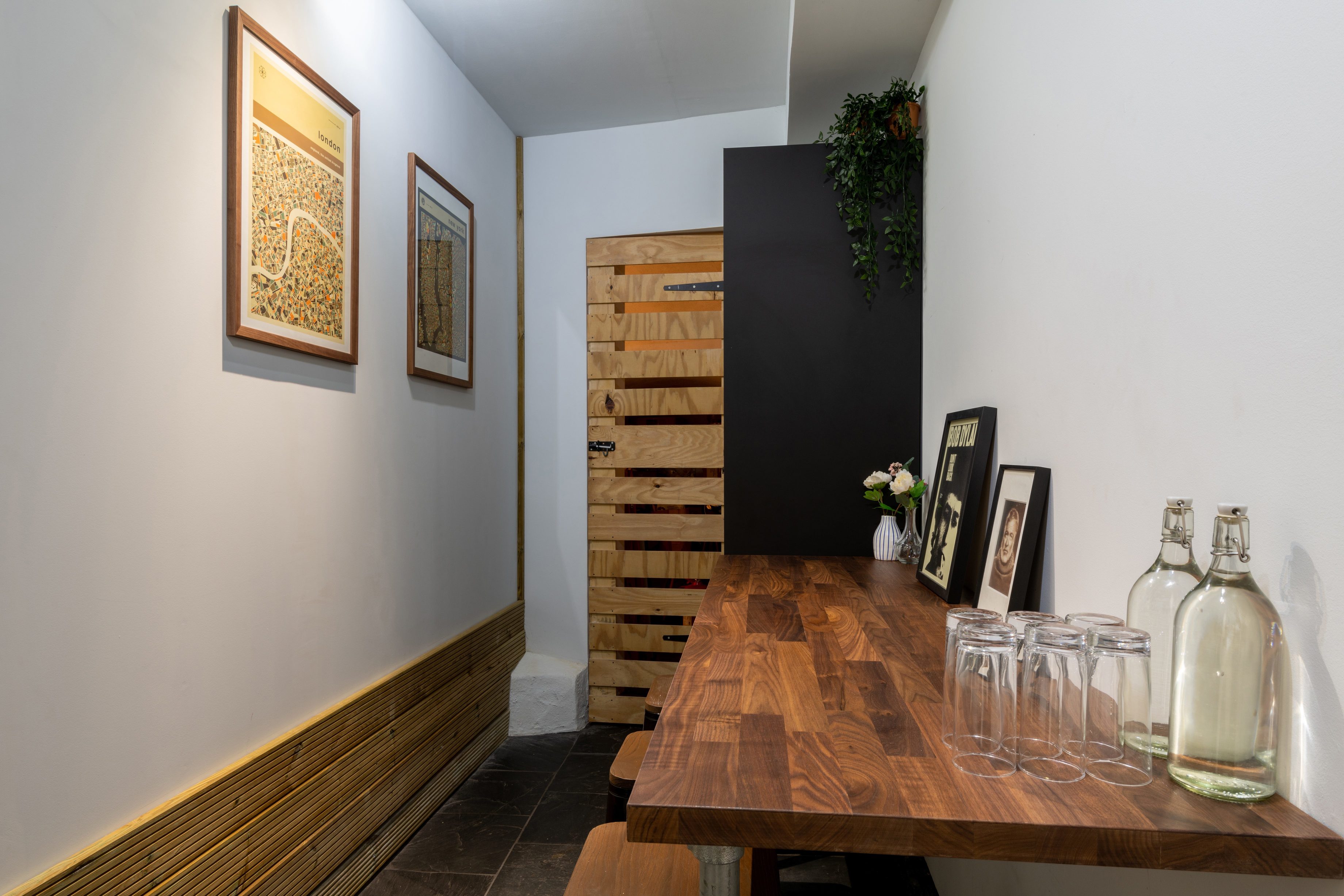 Sleek Meeting Room 2 hallway with wooden table for pre-event mingling and registration.