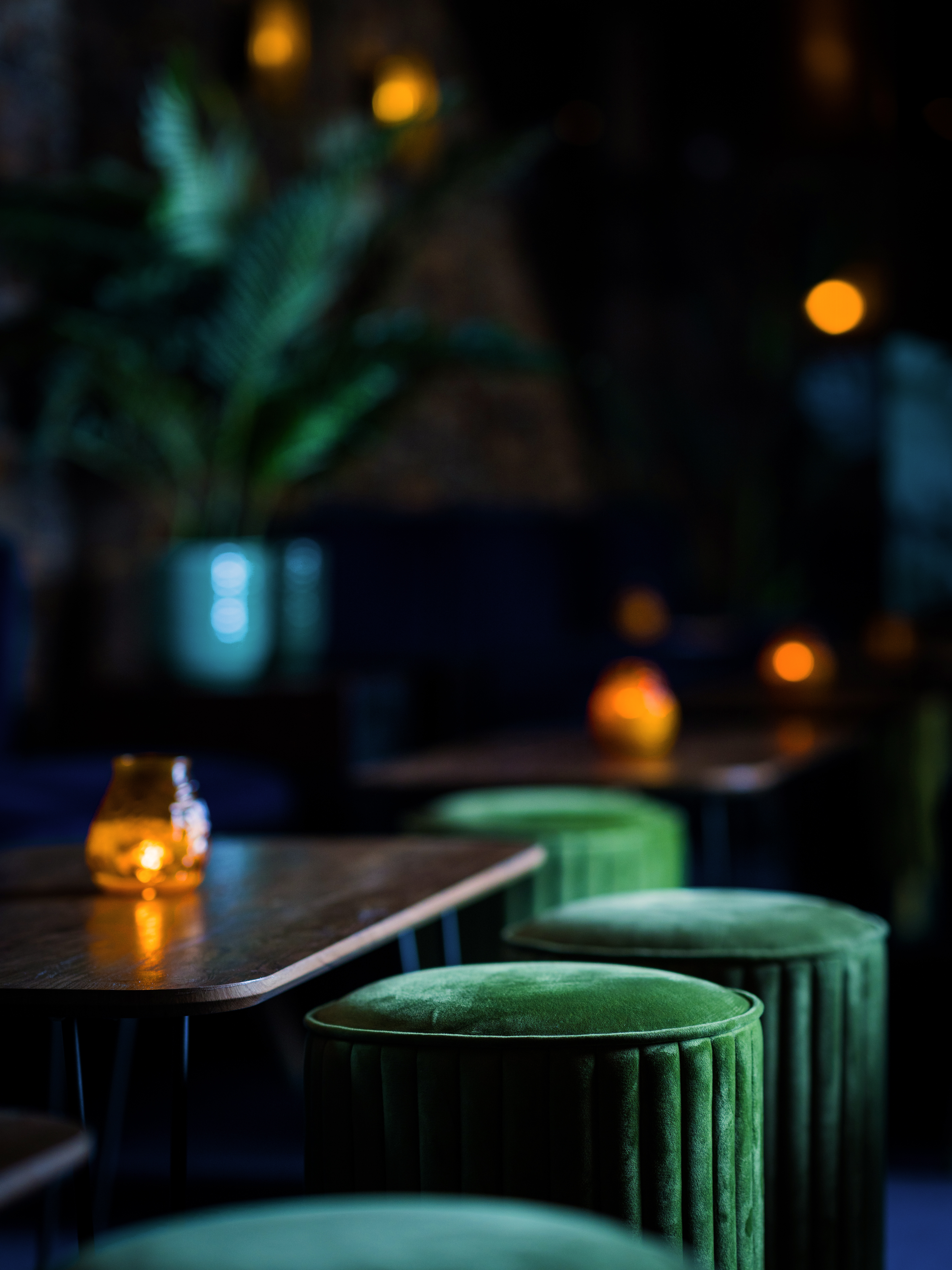 Stylish event space at Trailer Happiness with elegant candlelight and vibrant seating.