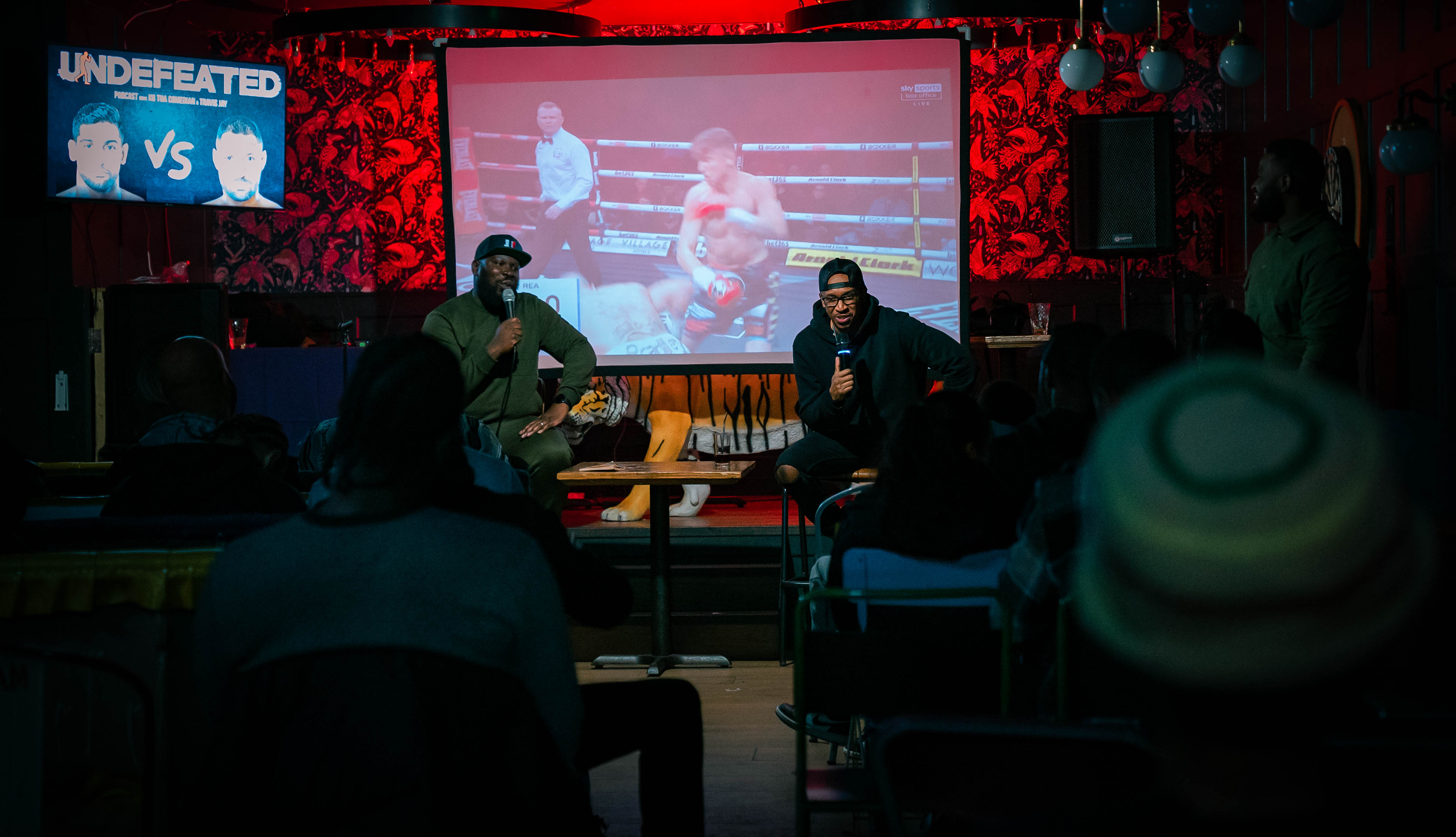 Boxing match at Tigers Lounge with vibrant decor, perfect for sports watch parties.