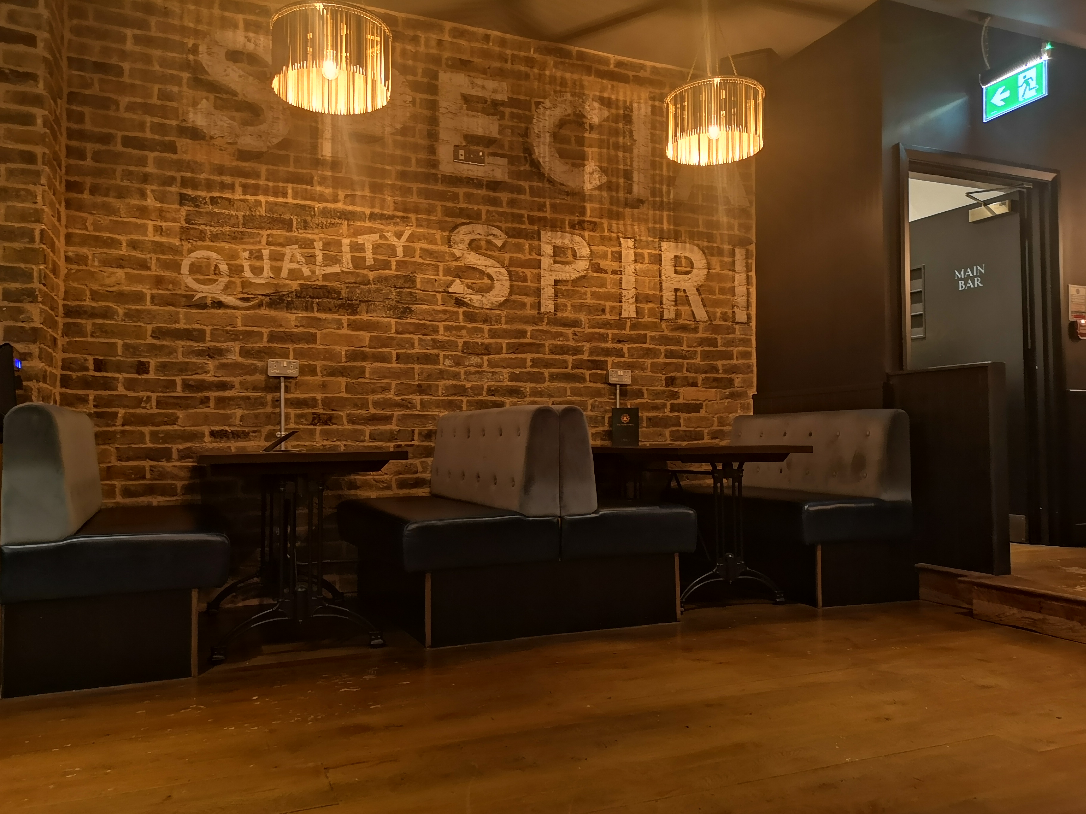 Cozy Gin Bar with exposed brick, perfect for private events and networking.