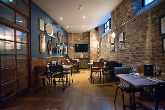 Stylish Trinity Bell Room with exposed brick, perfect for networking events and dinners.