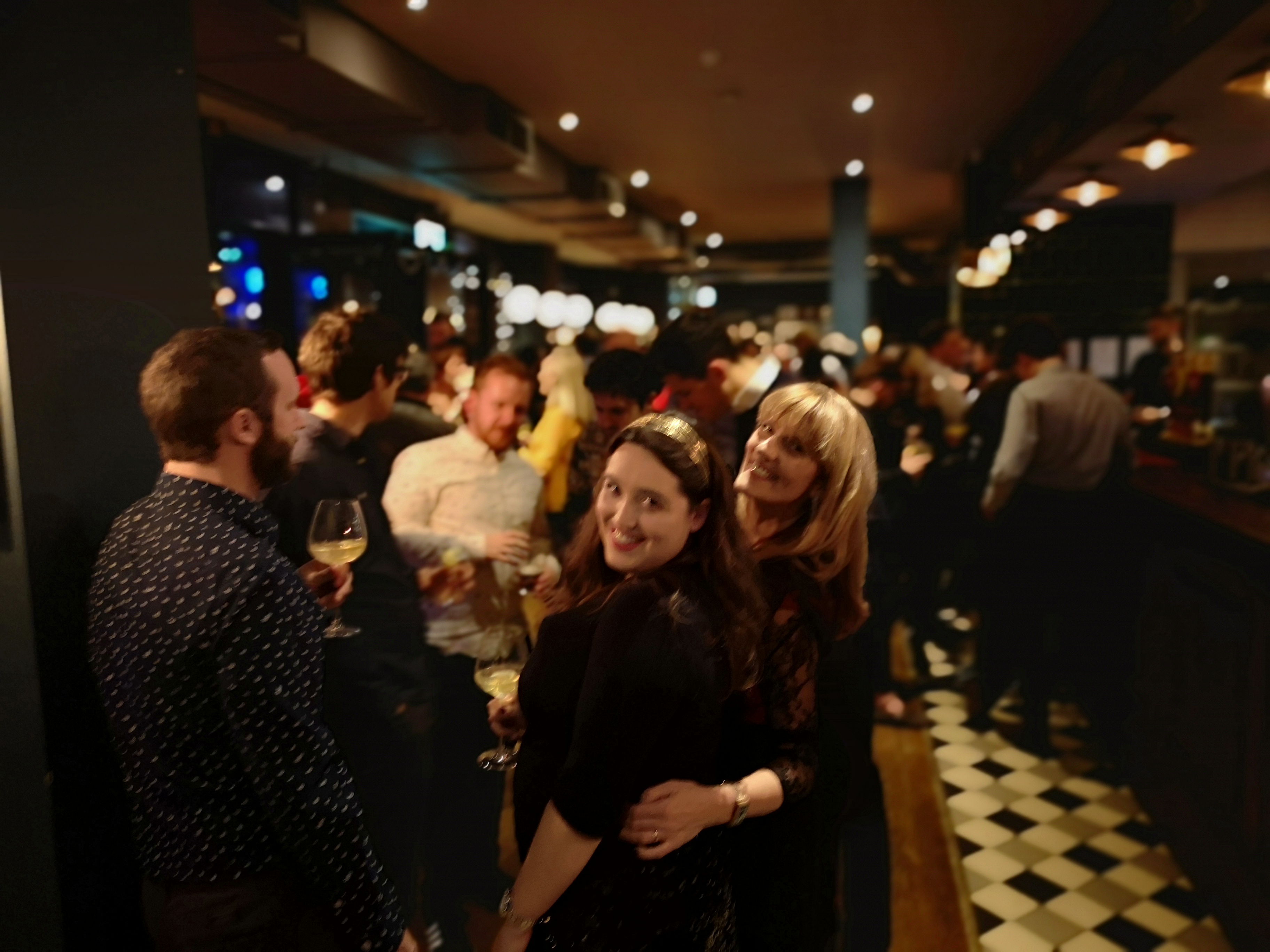Vibrant networking event at The Main Bar, Trinity Bell, with attendees enjoying drinks.