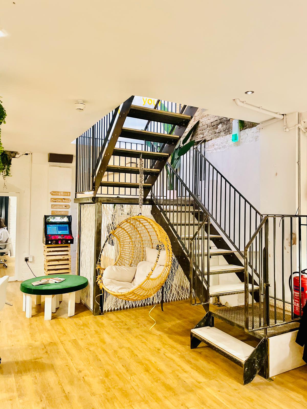 Modern multi-level event space with stylish staircase at Cobalance Cafe for networking events.