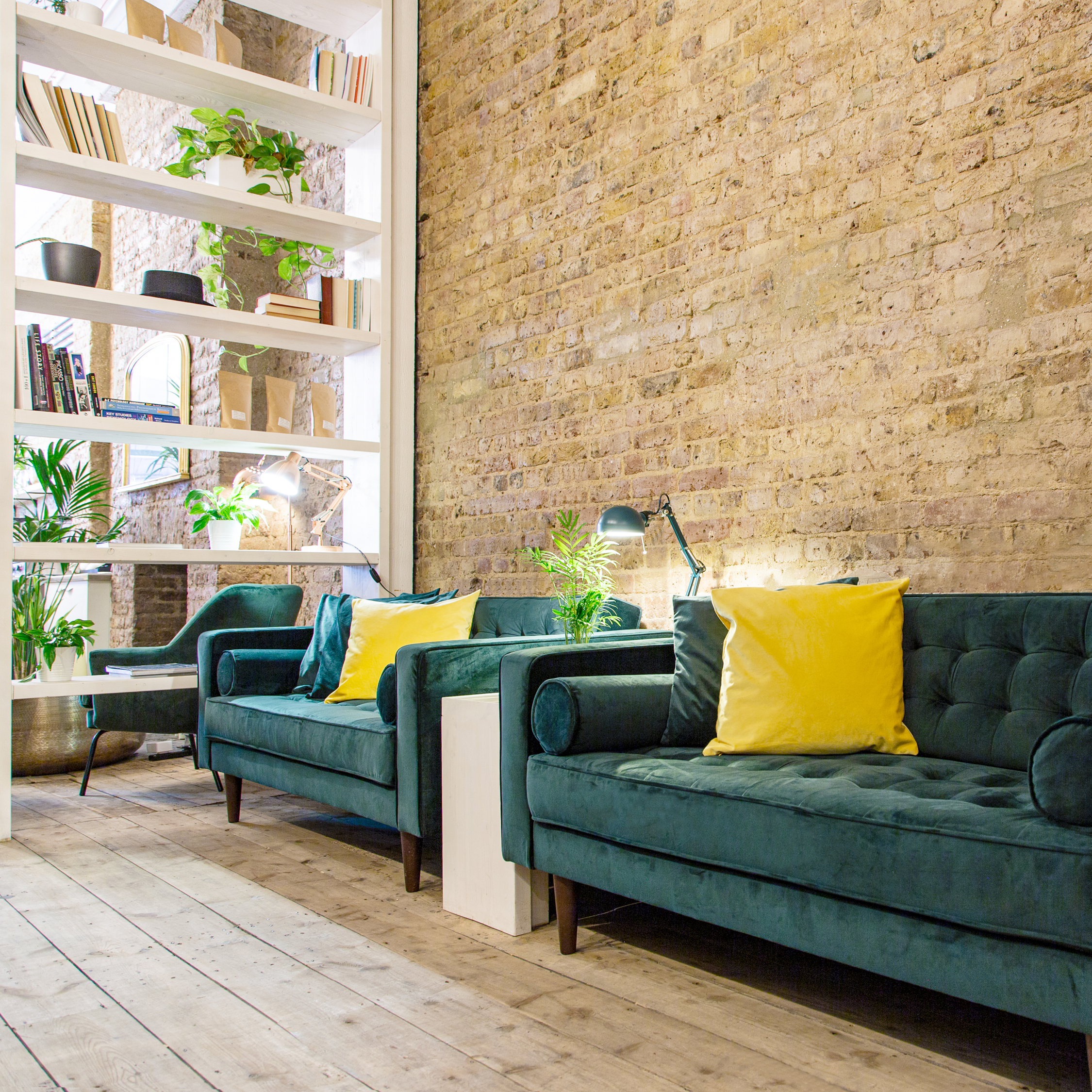 Stylish lounge with teal sofas for networking events at Cobalance Cafe.