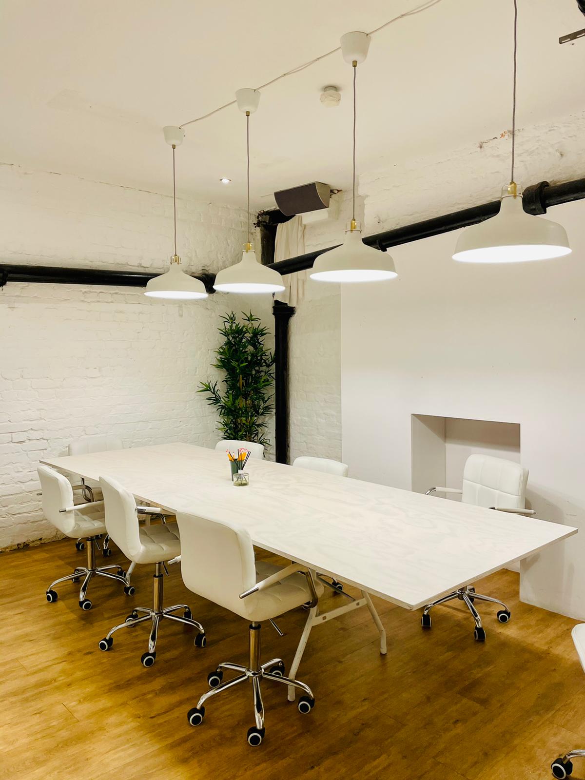 Modern minimalist meeting room at Cobalance Cafe, ideal for collaboration and brainstorming.