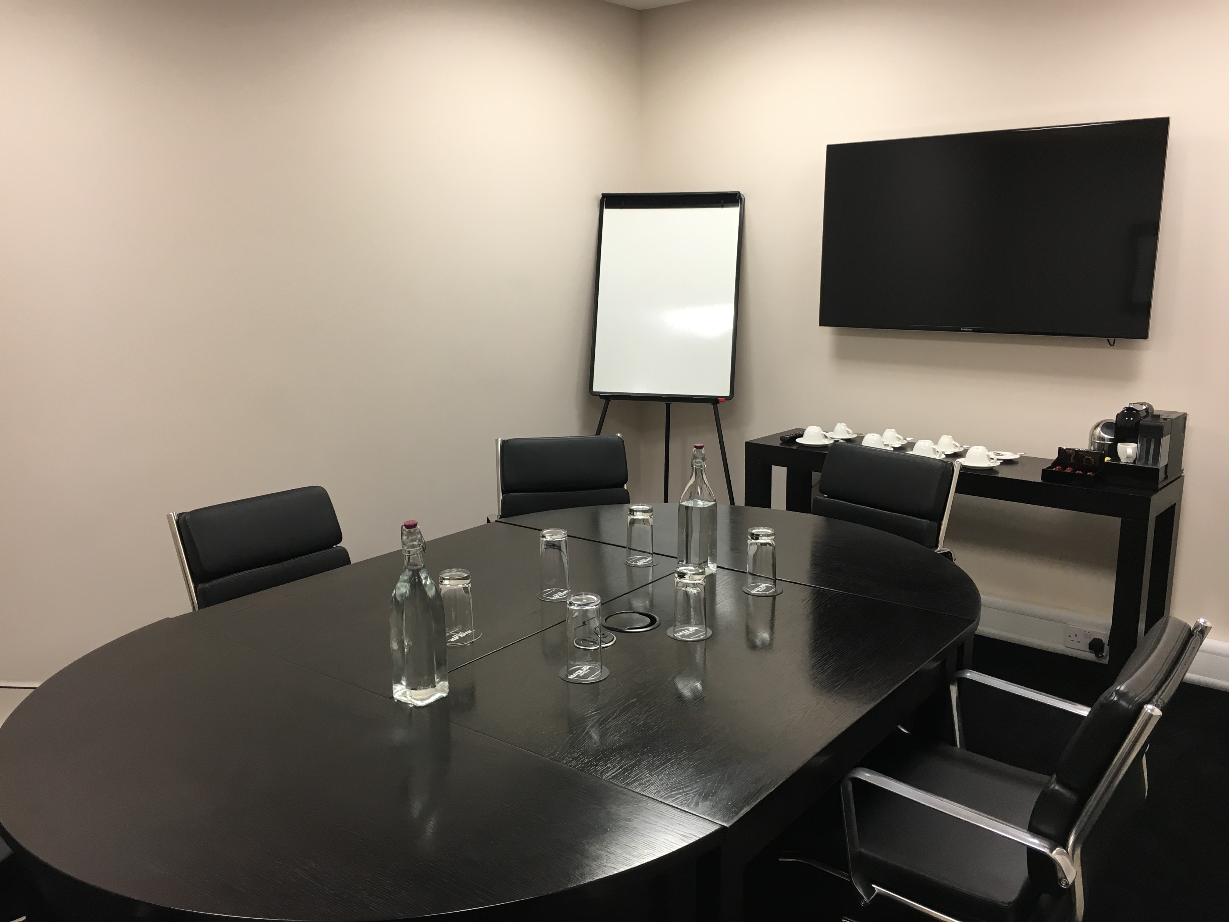 Nadler Soho Boardroom with sleek table, ideal for meetings and presentations.